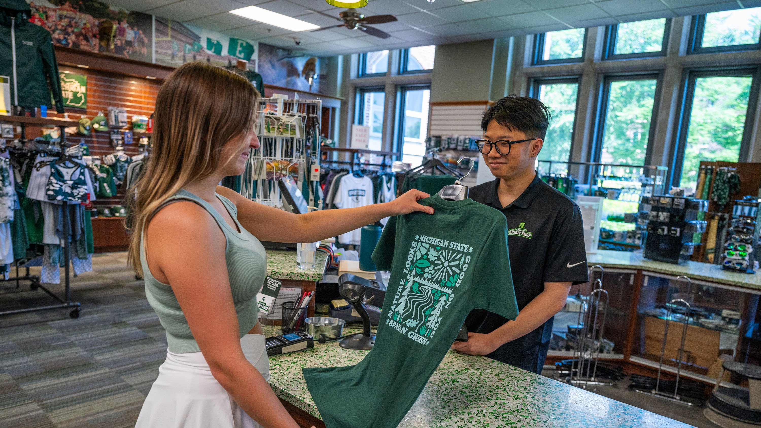 Student looking at recycled t-shirt in Spartan Spirit shop