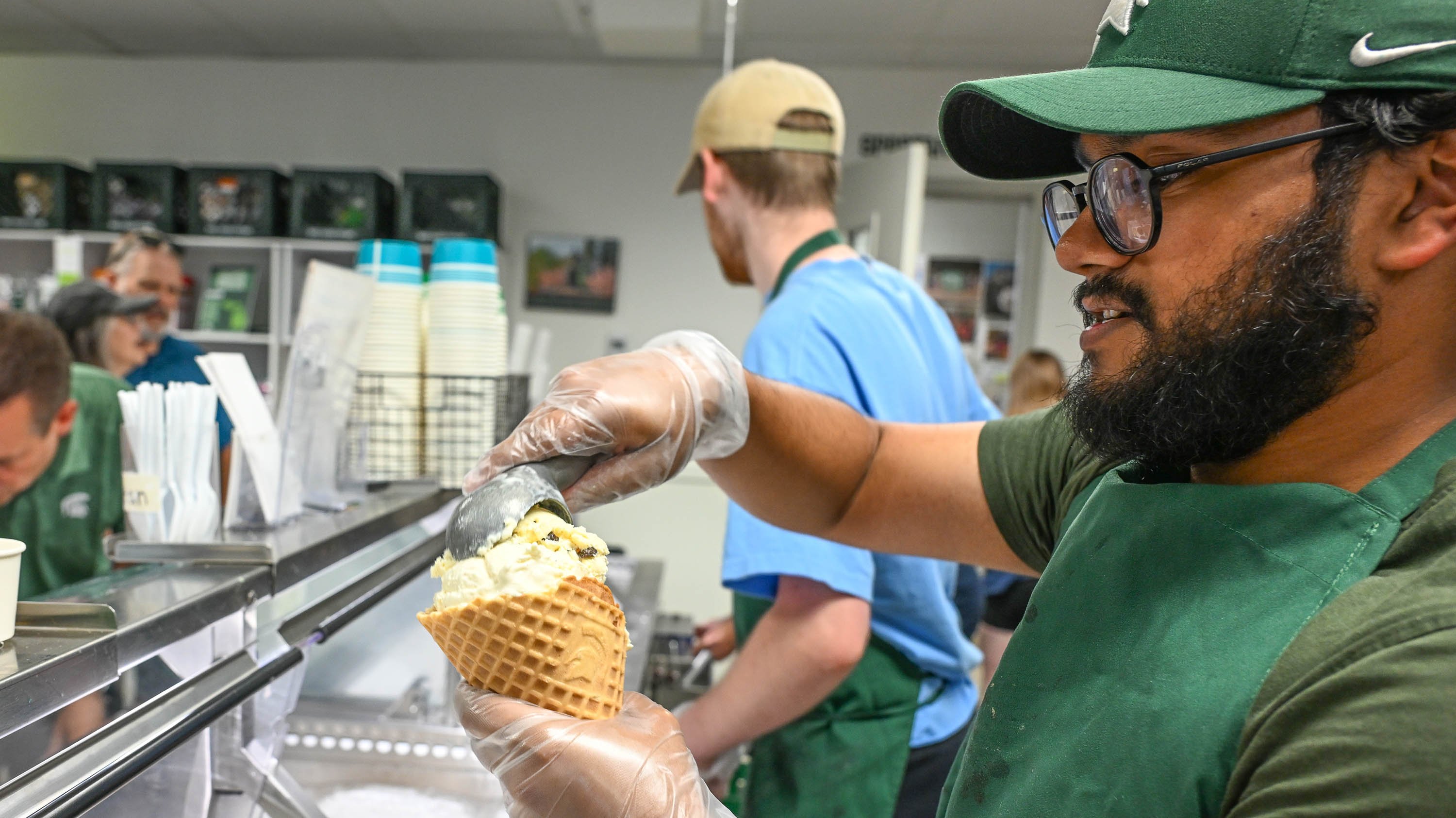 Dairy Store employee scooping ice cream