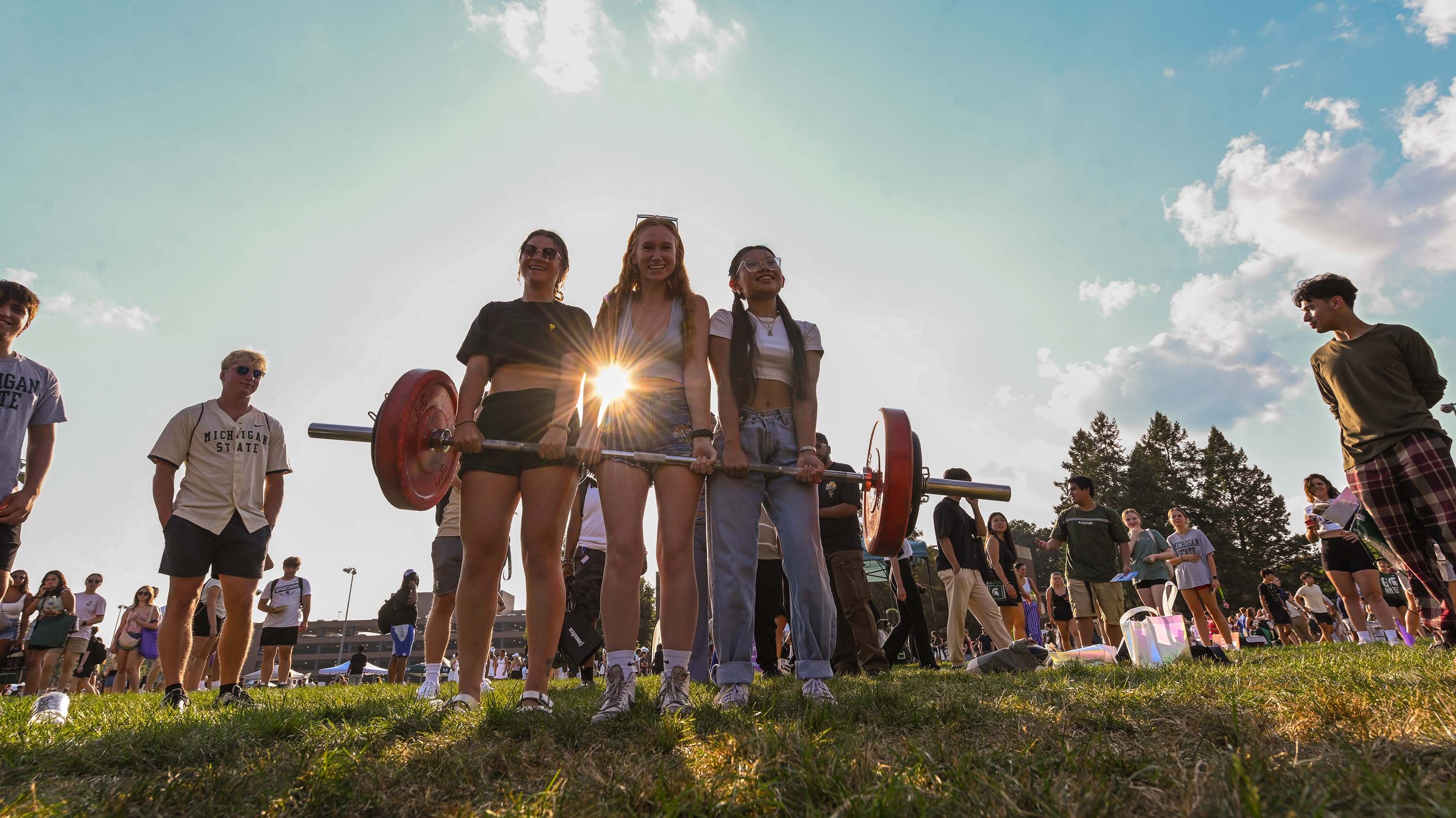 Three students lifting dumbbells at Sparticipation