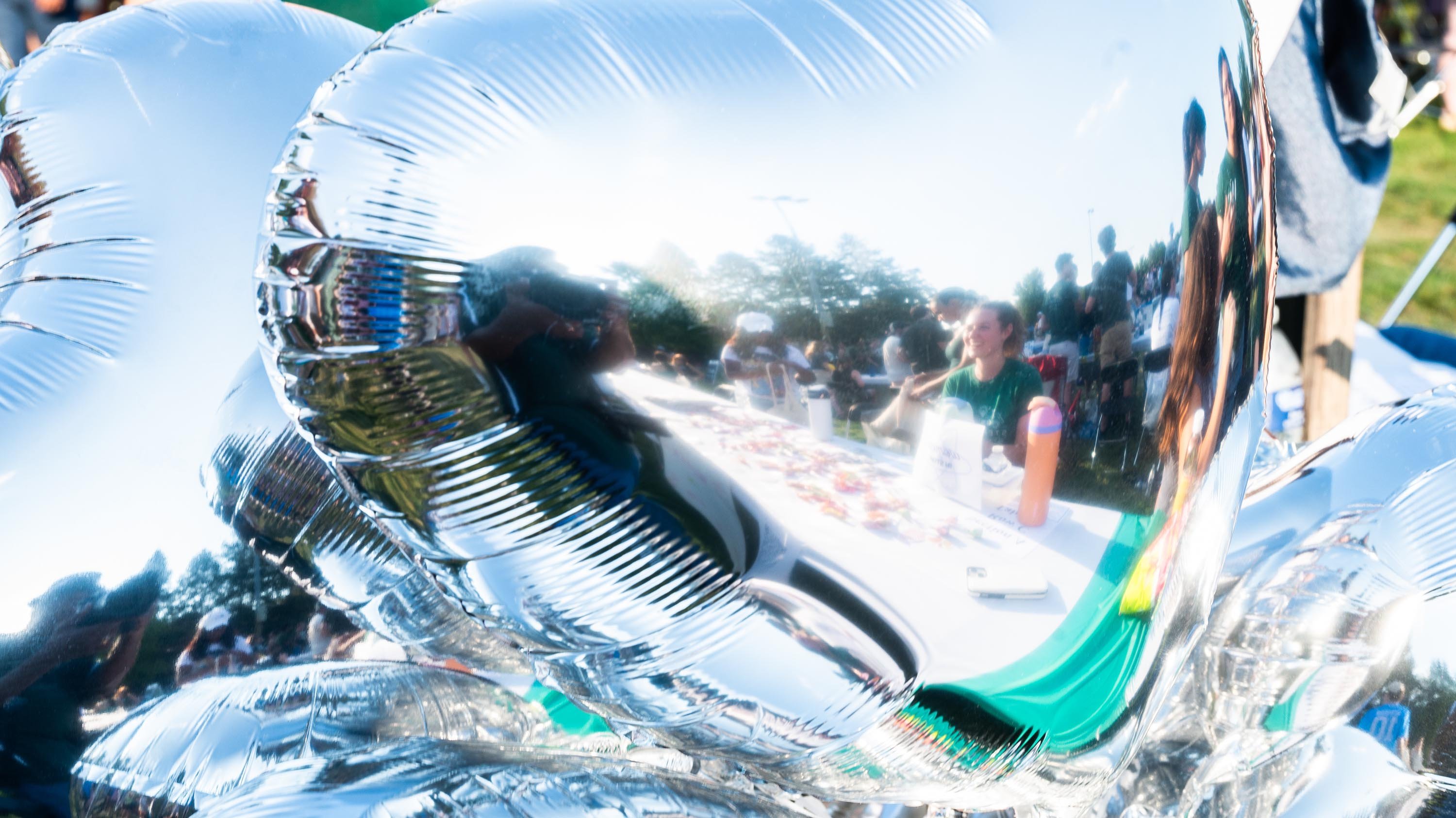 Close-up of mylar balloons reflecting tables at Sparticipation