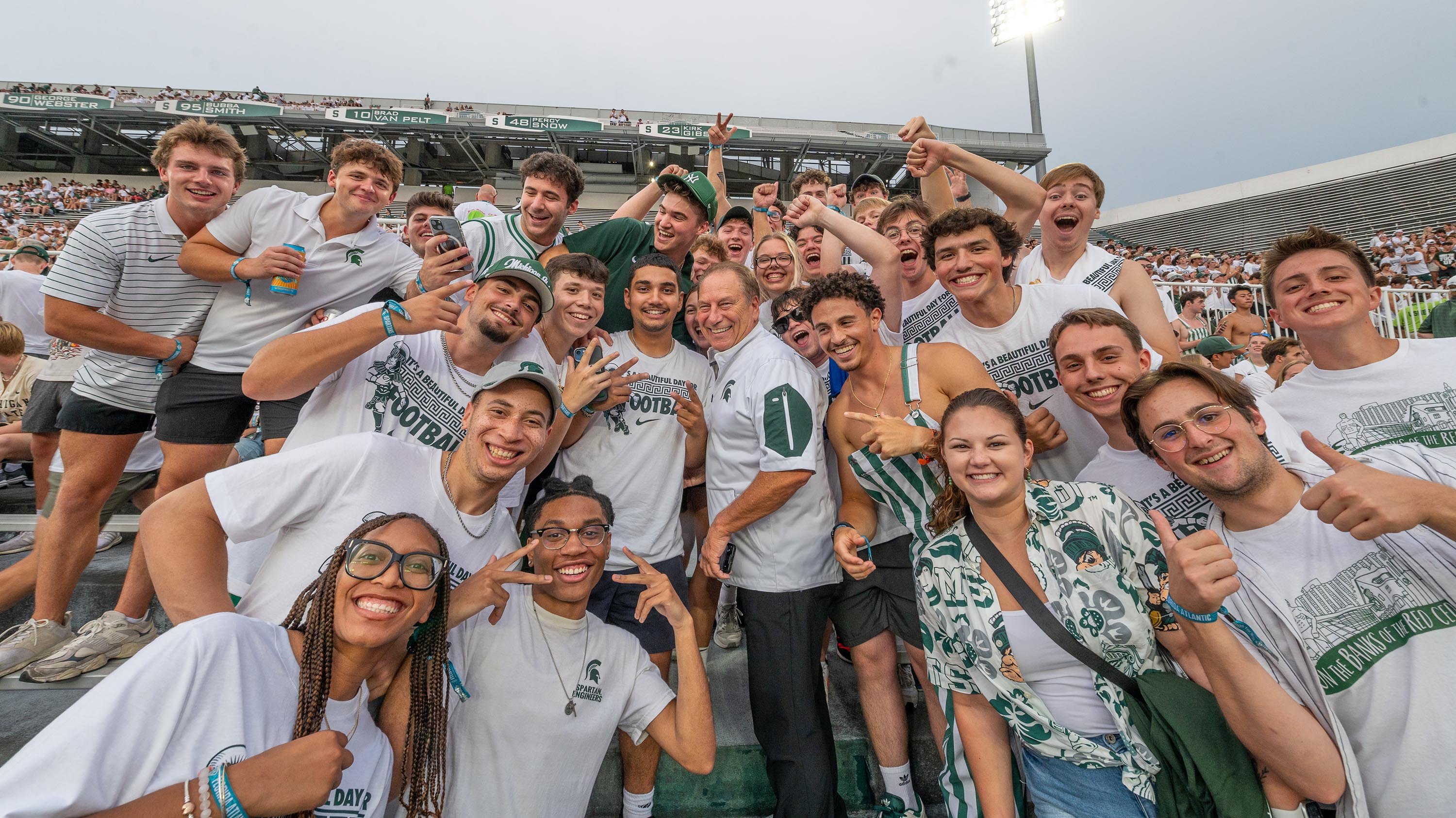 Tom Izzo with students at football game
