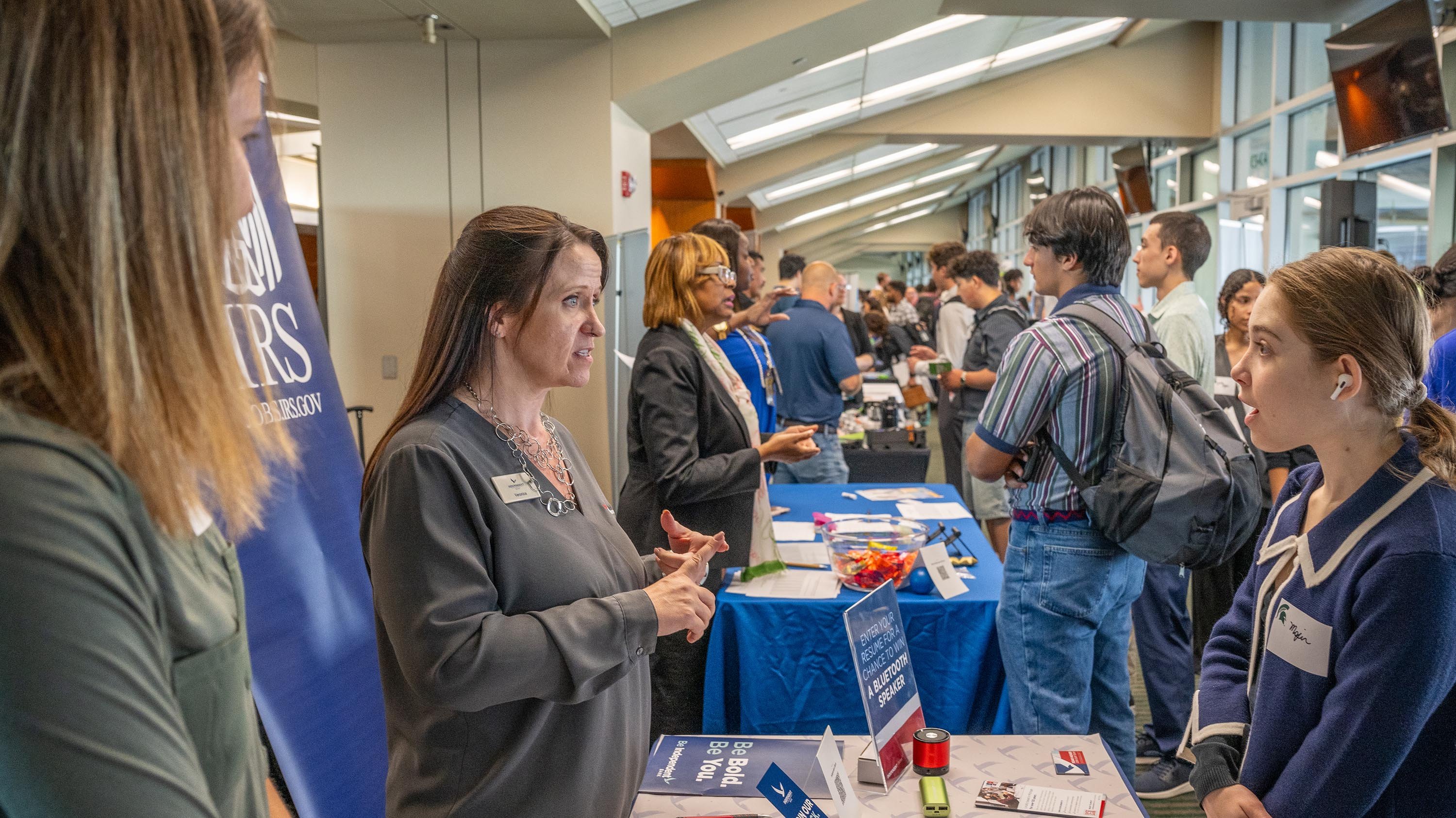 Employer speaking to student at career fair
