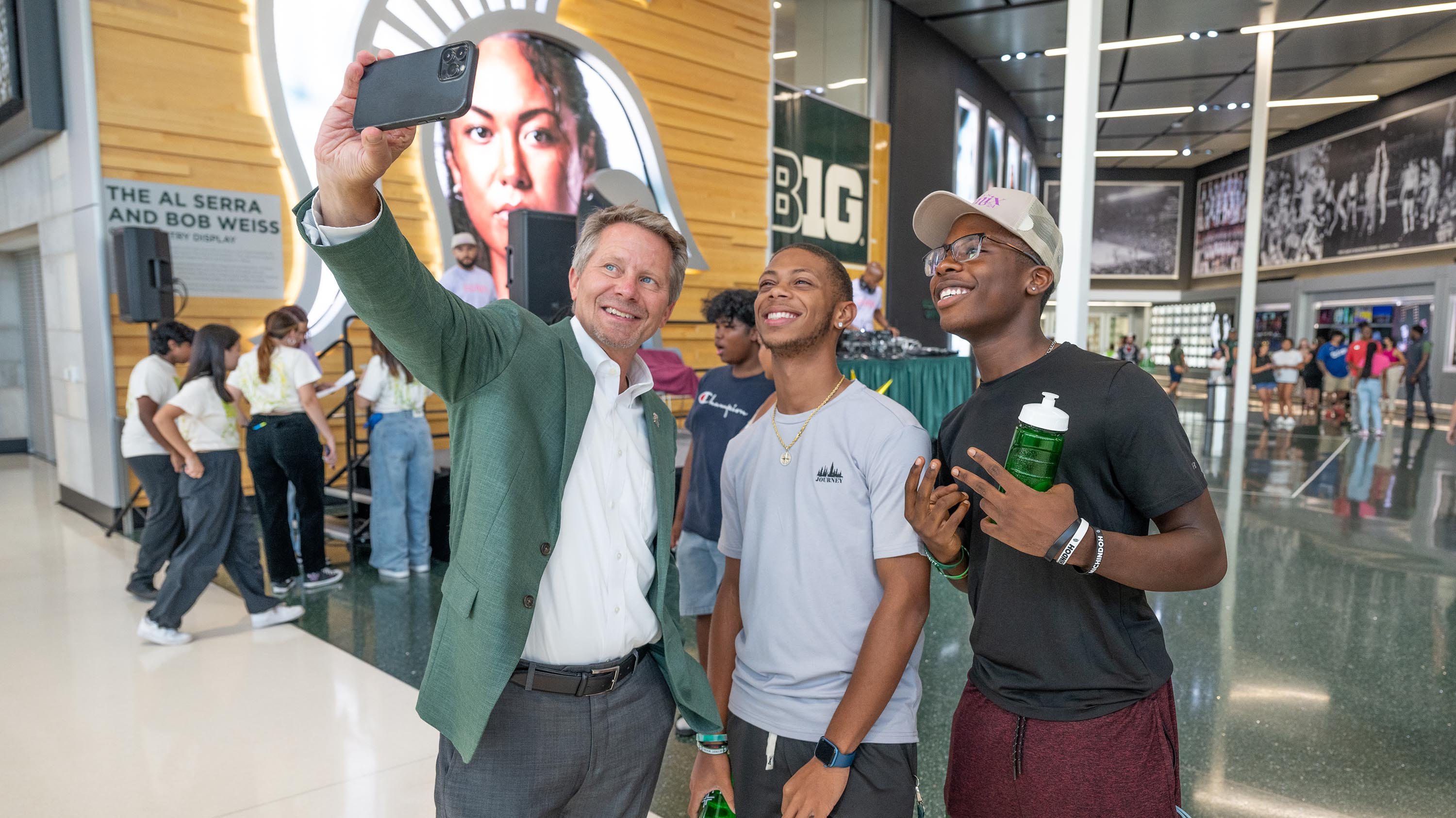 Kevin Guskiewicz taking selfie with students