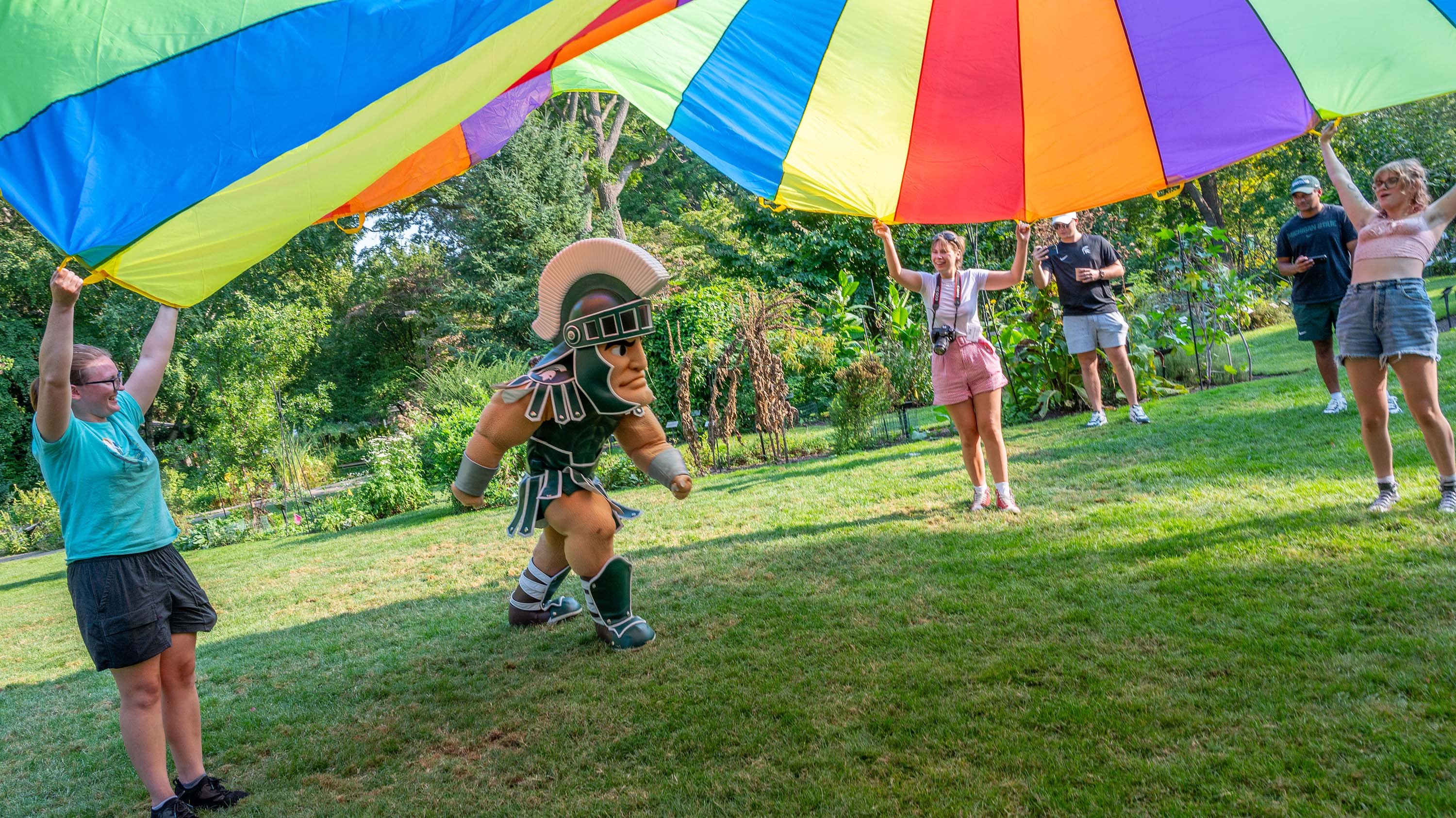 Sparty running under a parachute at BealFest