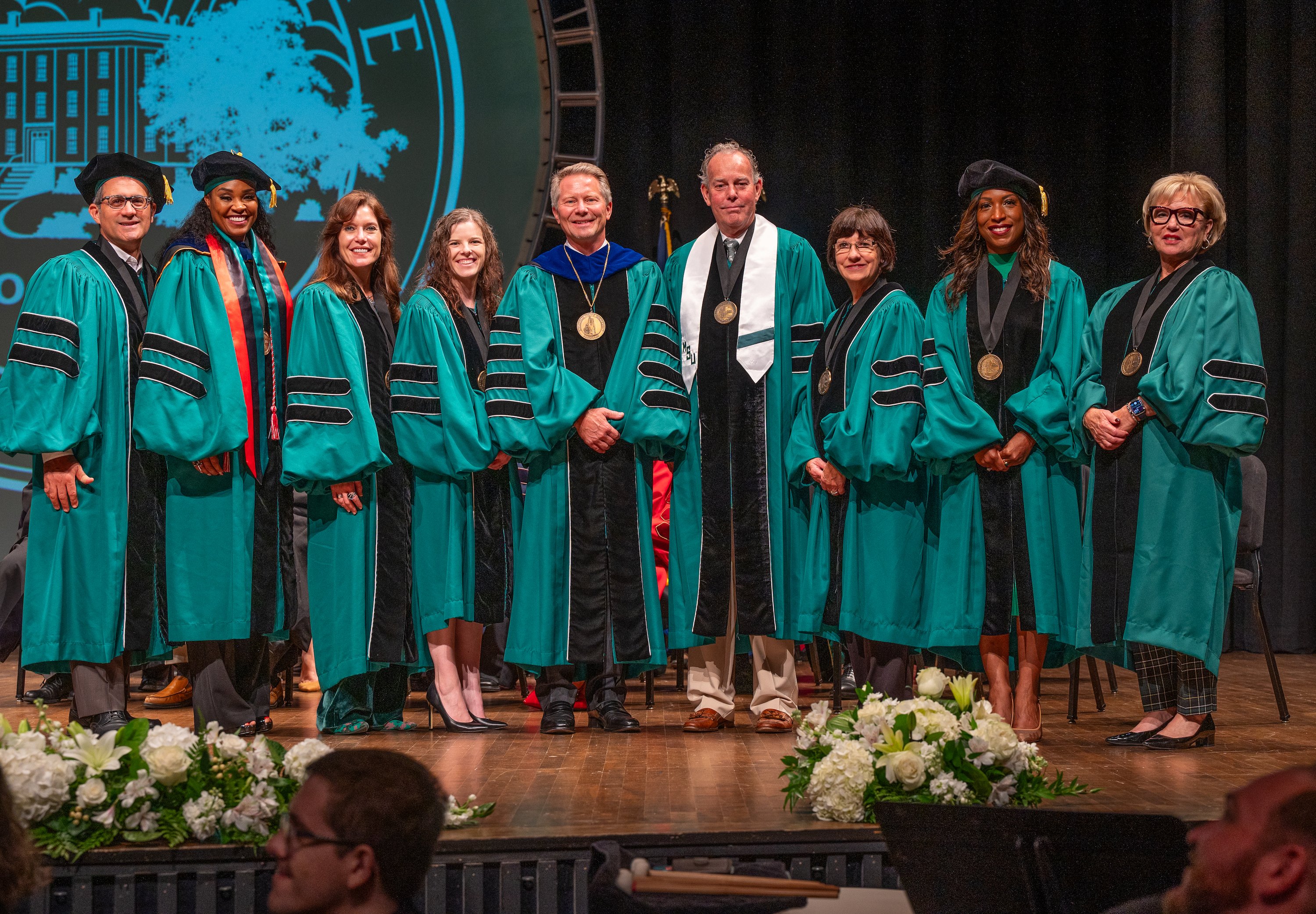MSU trustees and president stand for a picture during the investiture ceremony at Wharton Center.