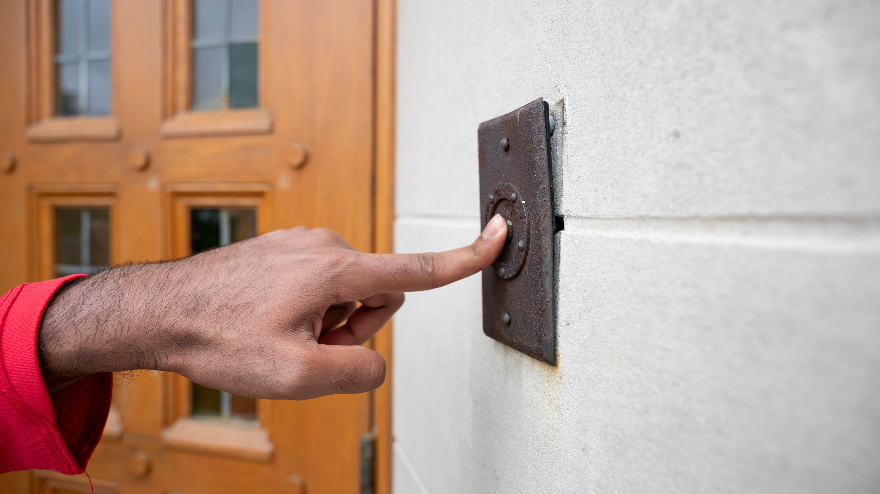 Hand ringing doorbell