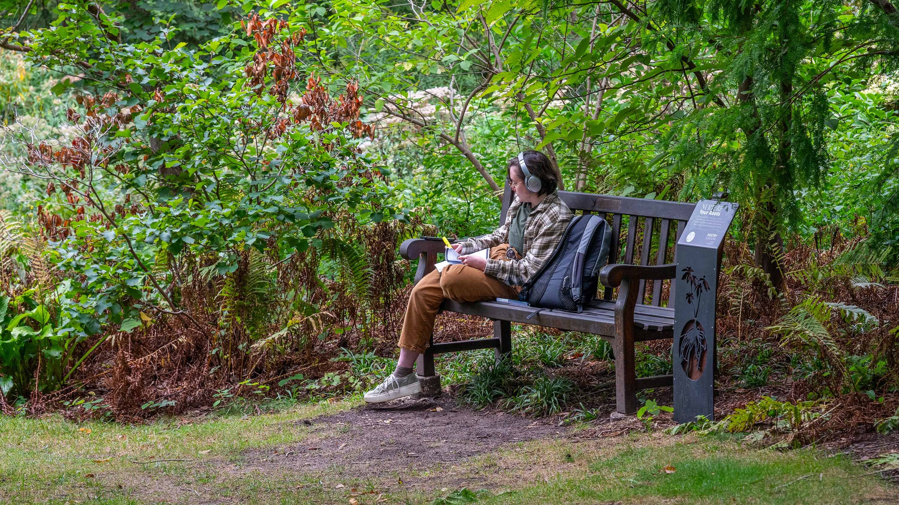 Person sitting on bench in Beal Garden