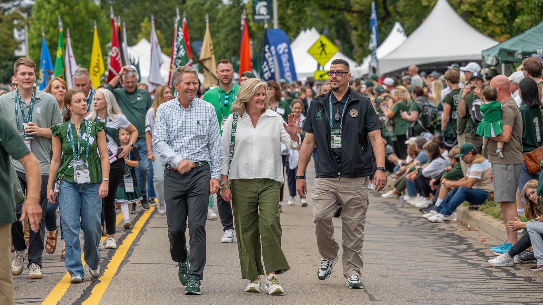 Kevin Guskiewicz and family marching with SMB before football game