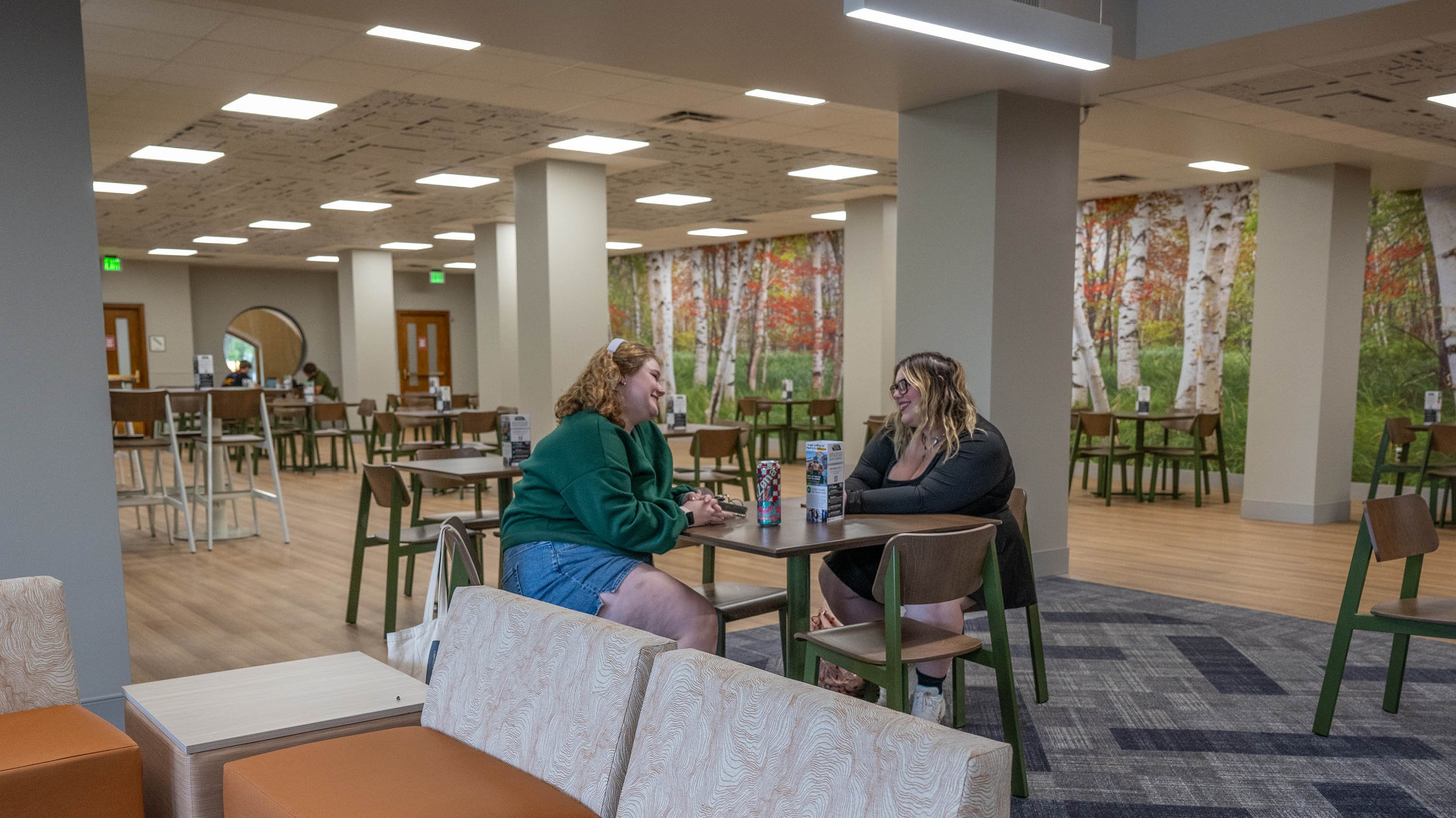 Two students sitting at a table in the MSU Union Lounge