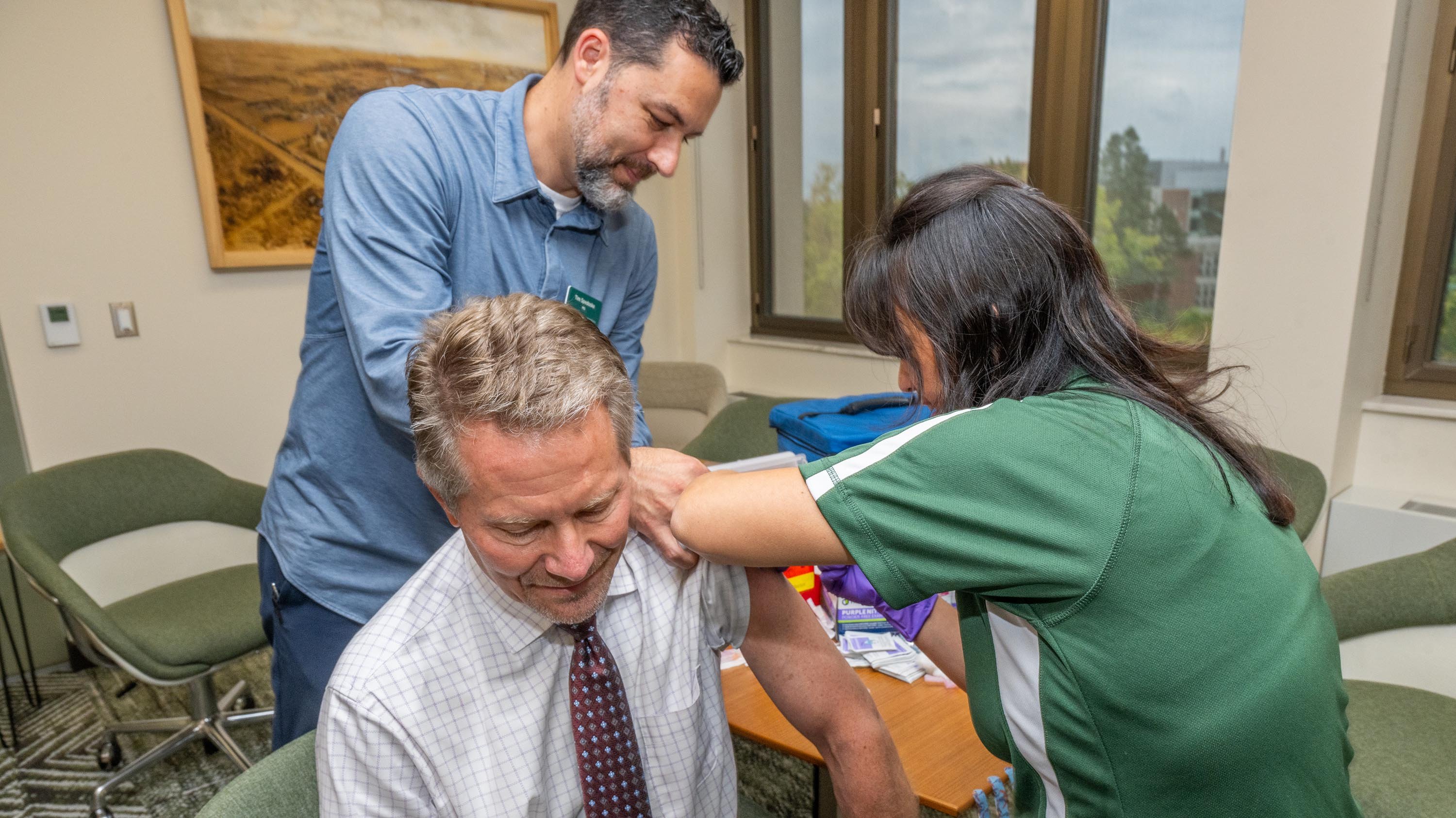 President Guskiewicz receiving a flu shot