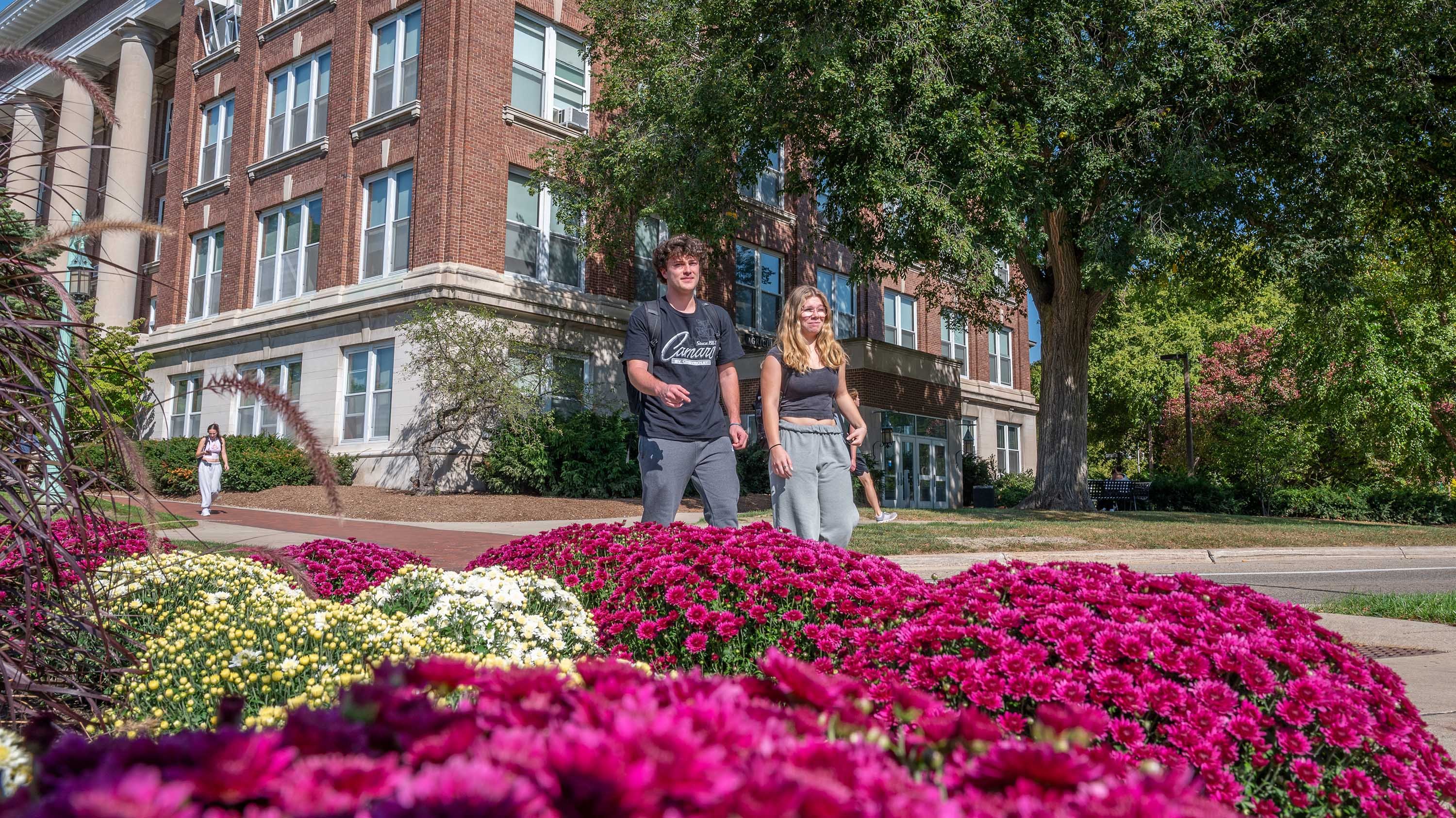 Mums in front of students walking