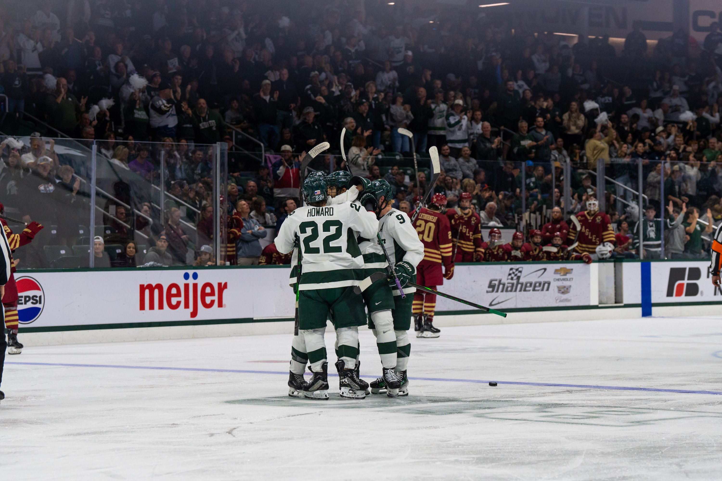 Spartan hockey players celebrate while on the ice at Munn Ice Arena.