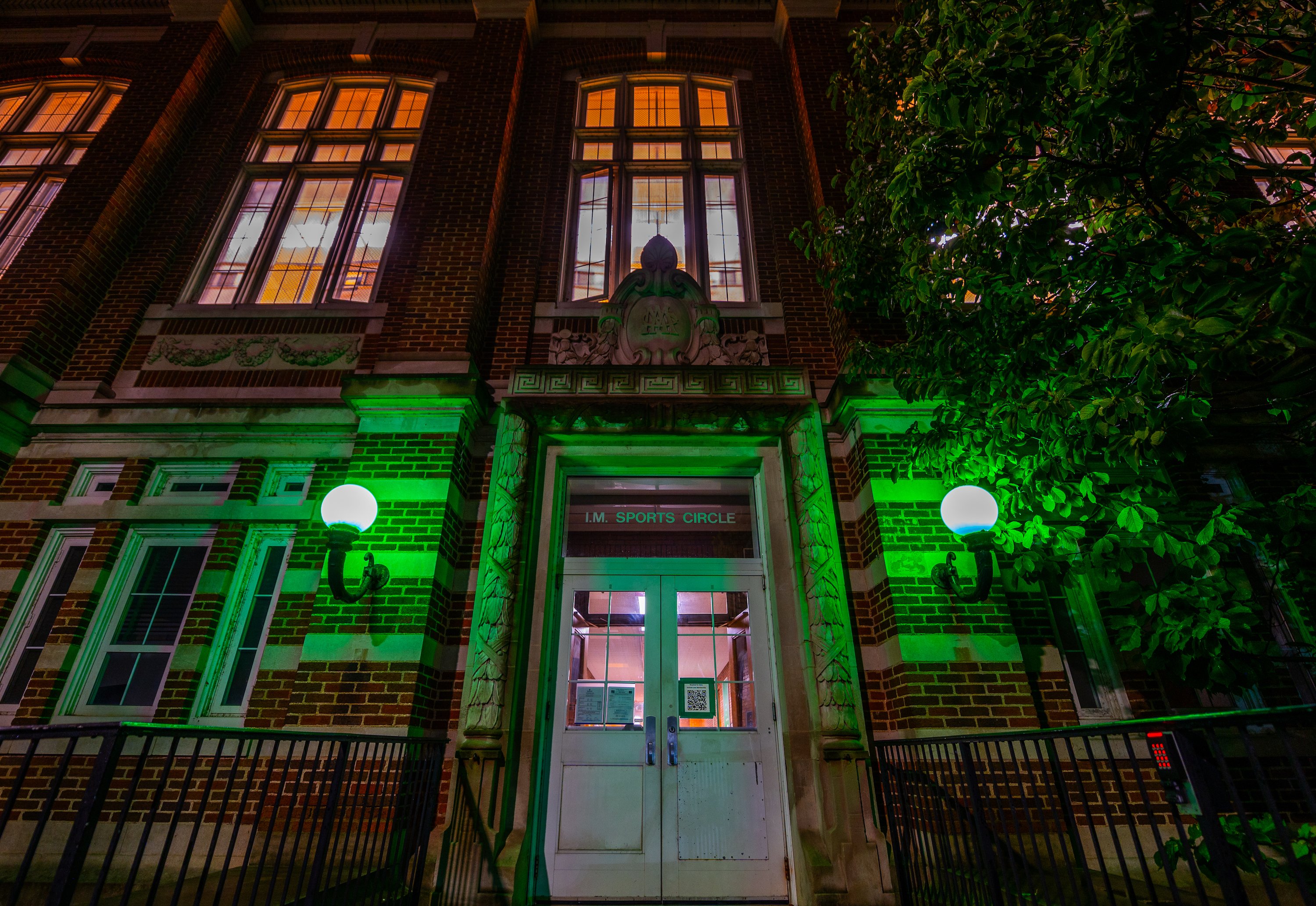 The front entrance to IM Circle is lit up green.