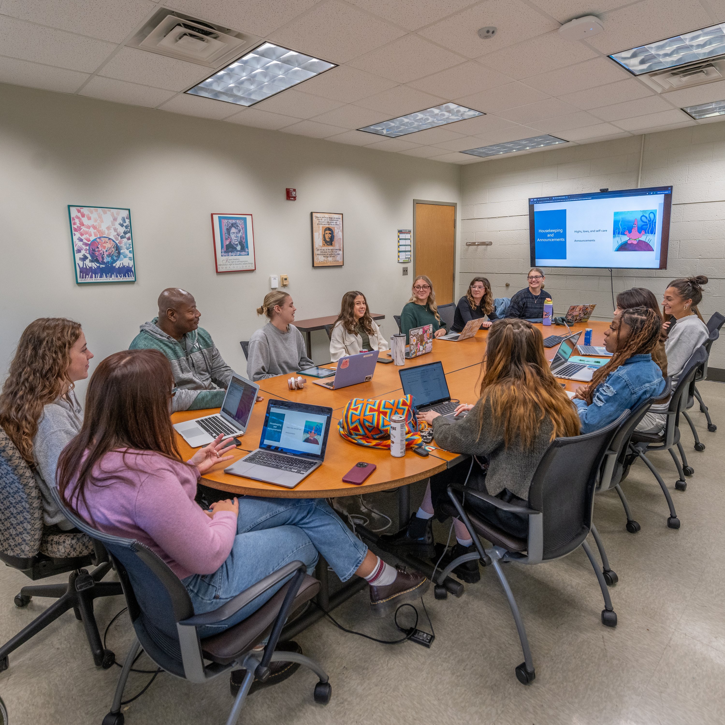 Students sit at a round table during a class.