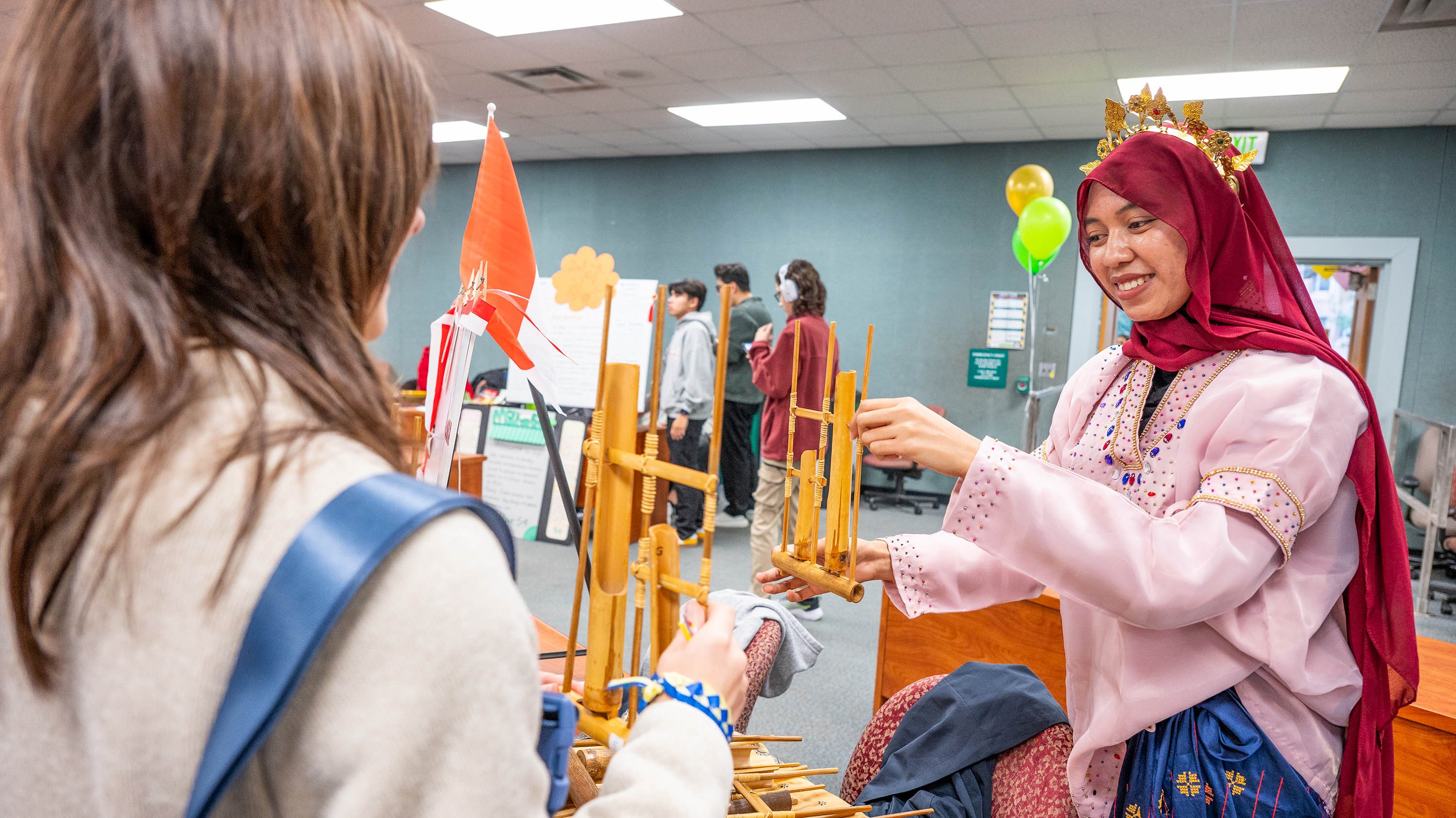 Student holding bamboo instrument