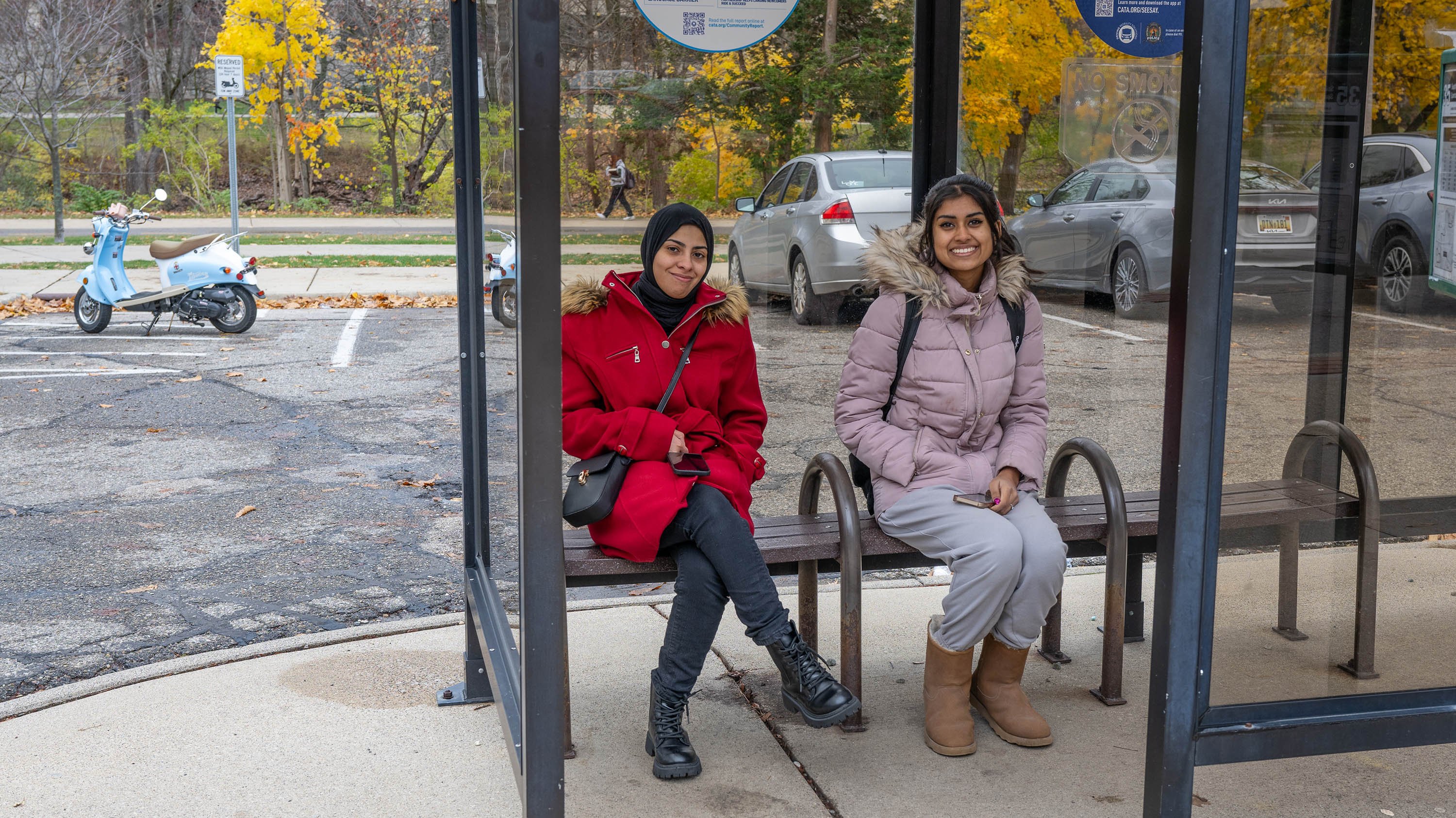 Two students waiting at bus stop