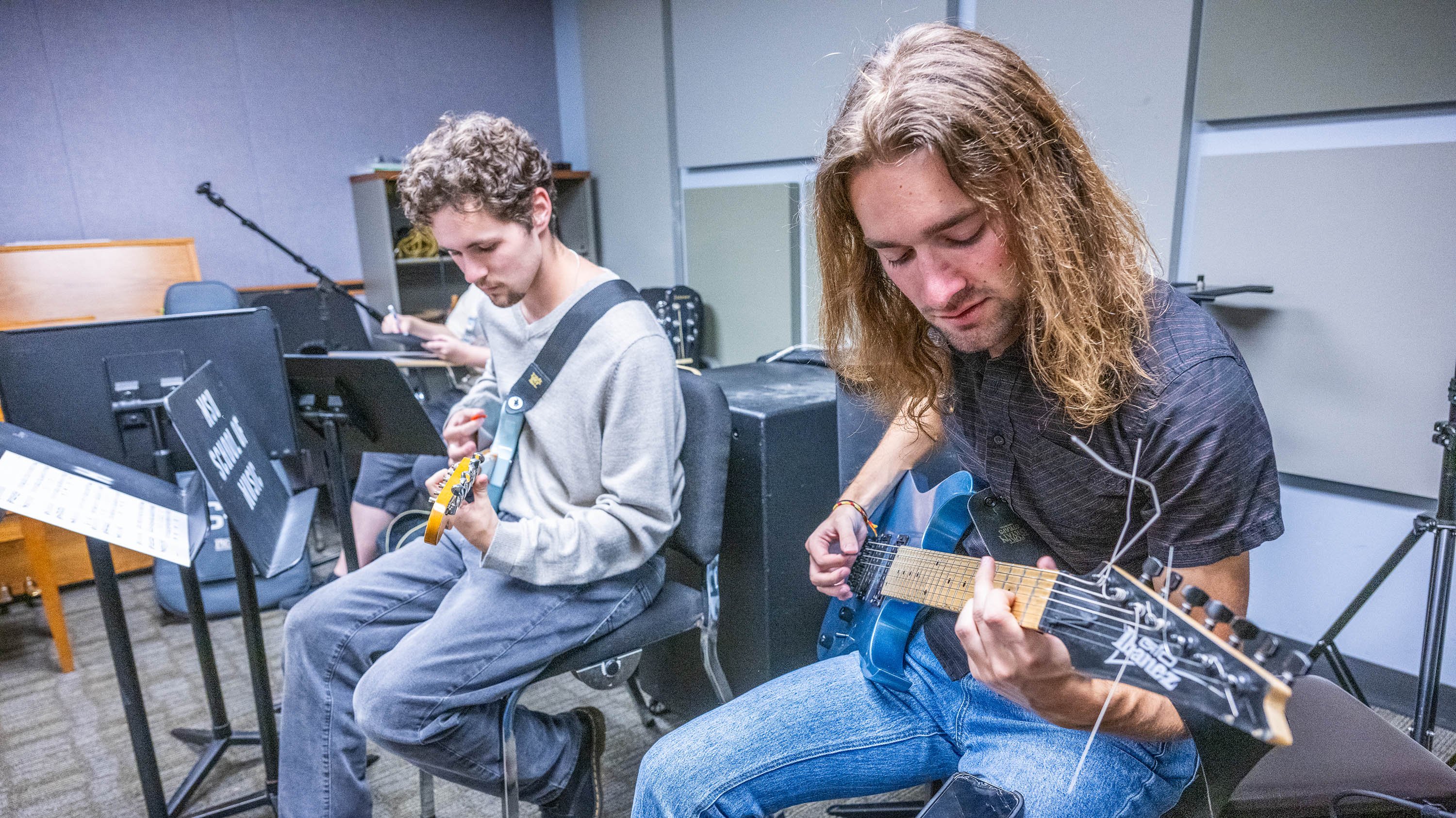 Students playing guitars