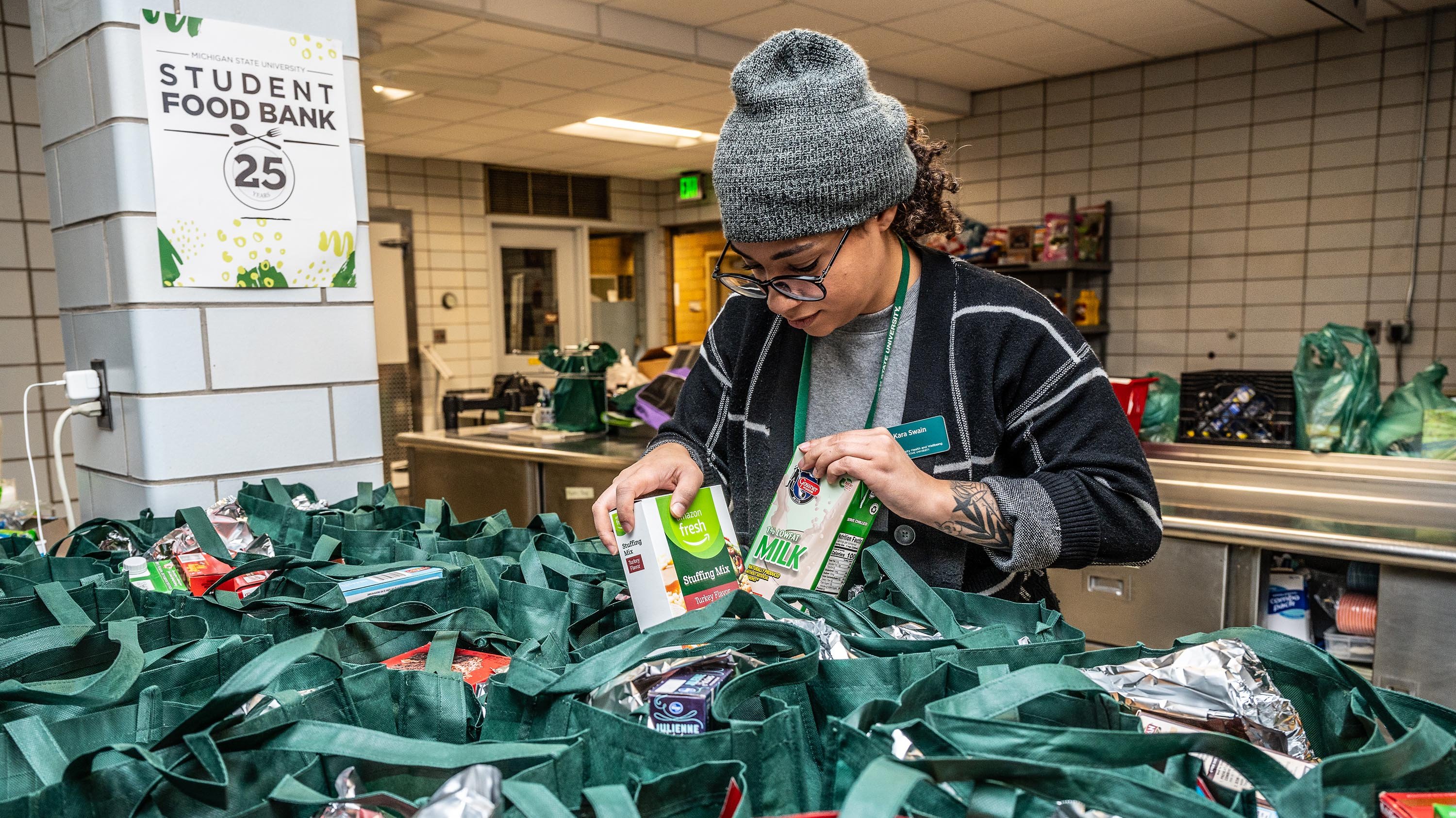 Kara Swain packing food into bags at food bank