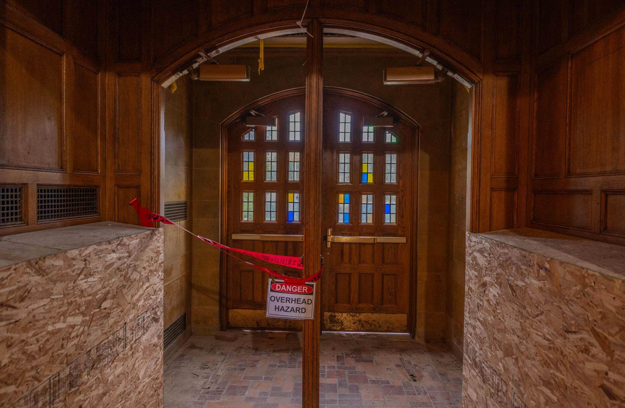 Campbell Hall exterior door with stained-glass under construction.