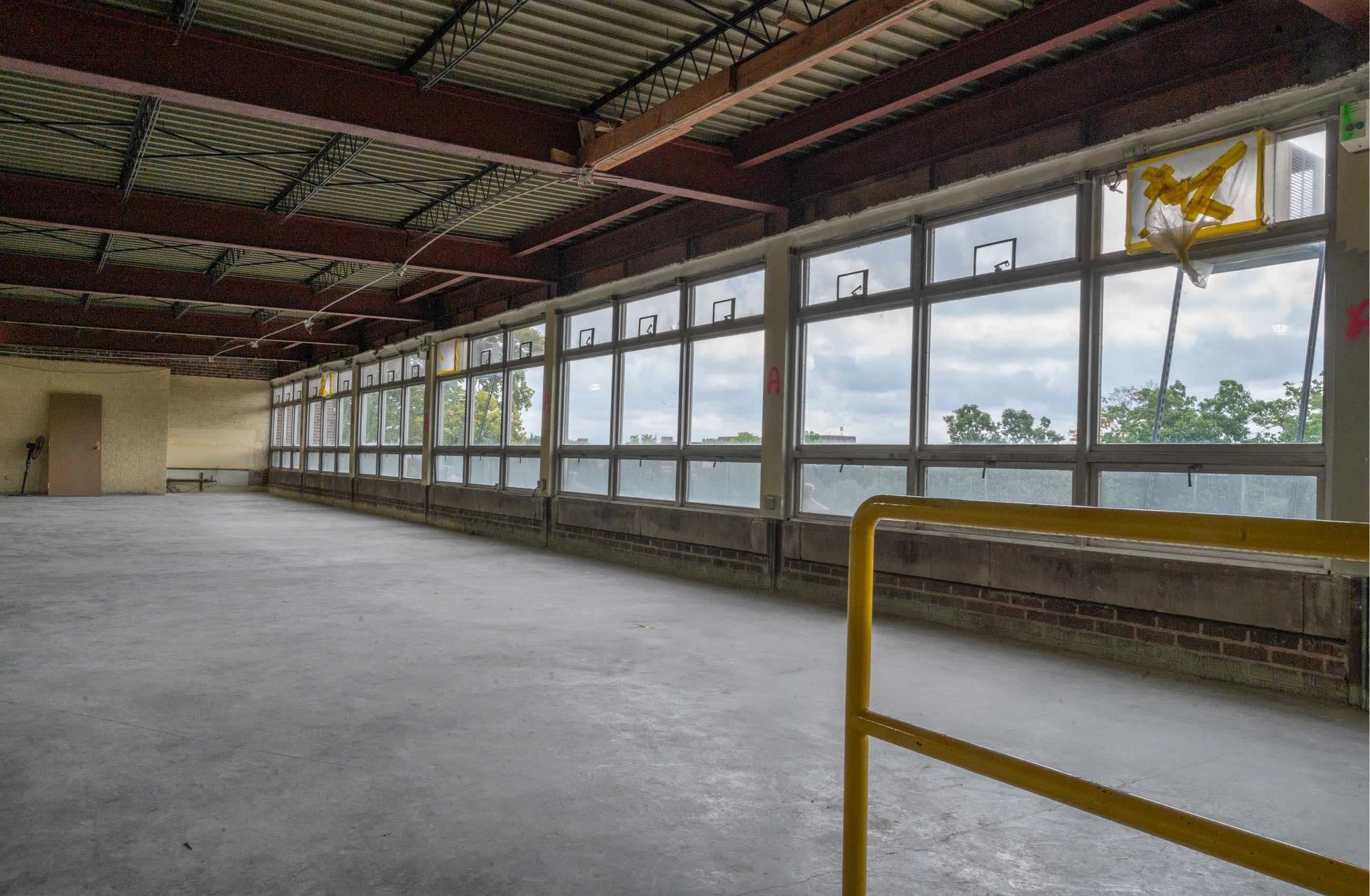 View from inside of the MSU Museum of a long row of windows under construction.