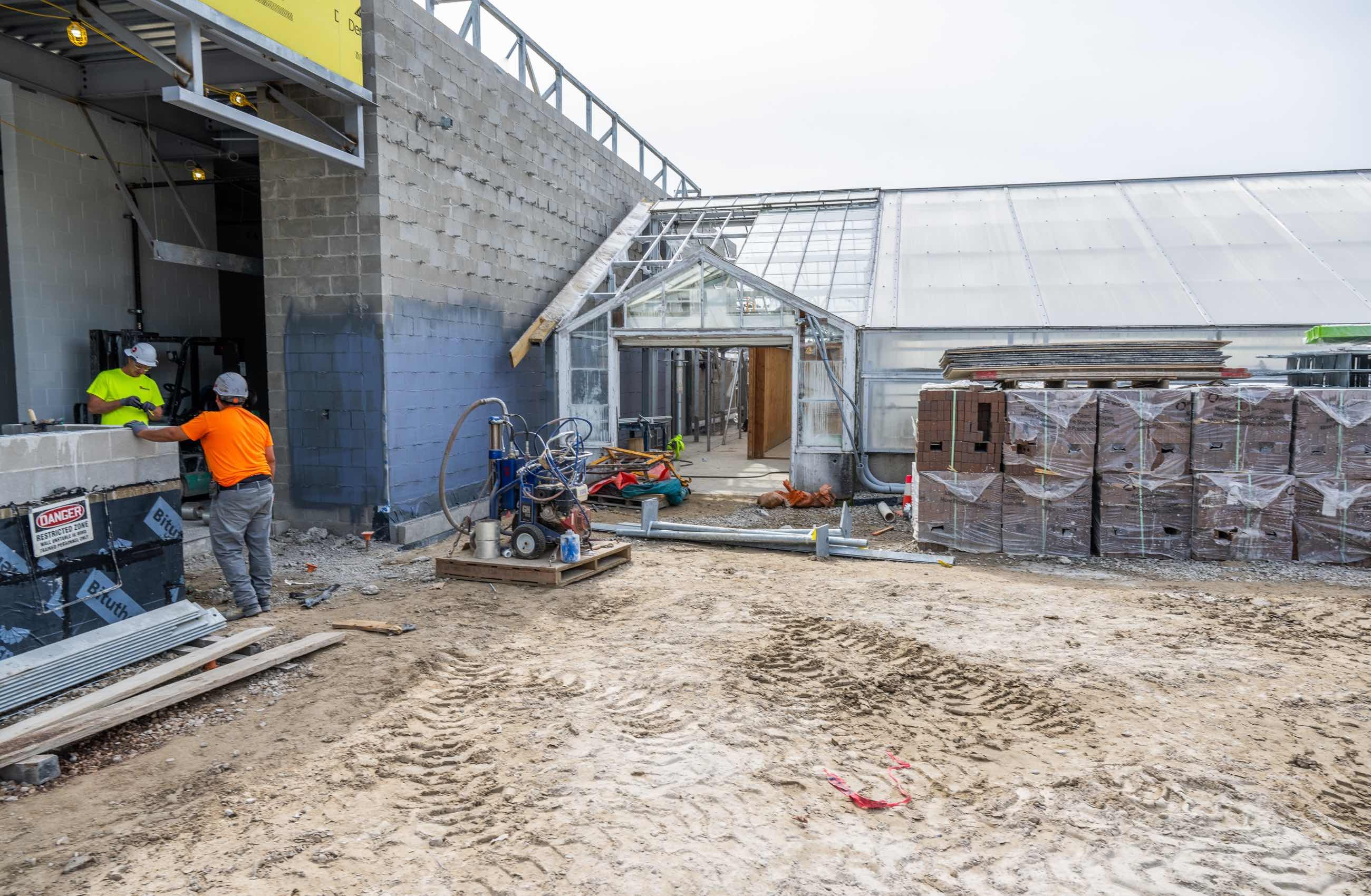Main cement structure and greenhouse under construction.