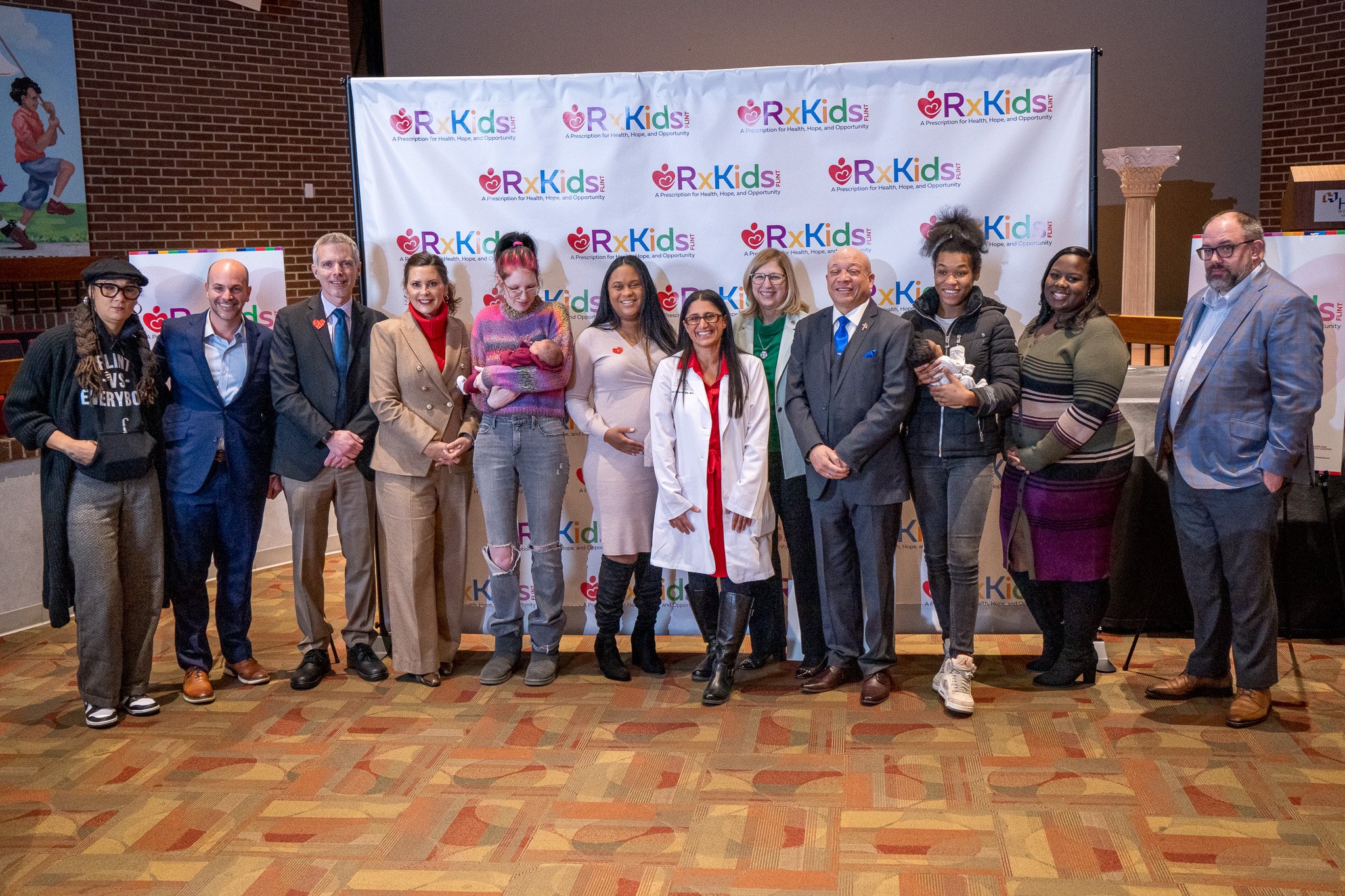 Individuals at the Flint Rx Kids program pose in front of a white background.