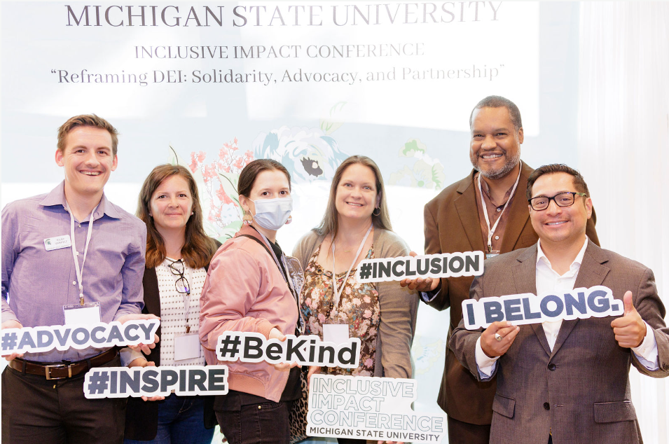 Planning committee member Florensio Hernandez (far R) with attendees from MSU's Office of Admissions.