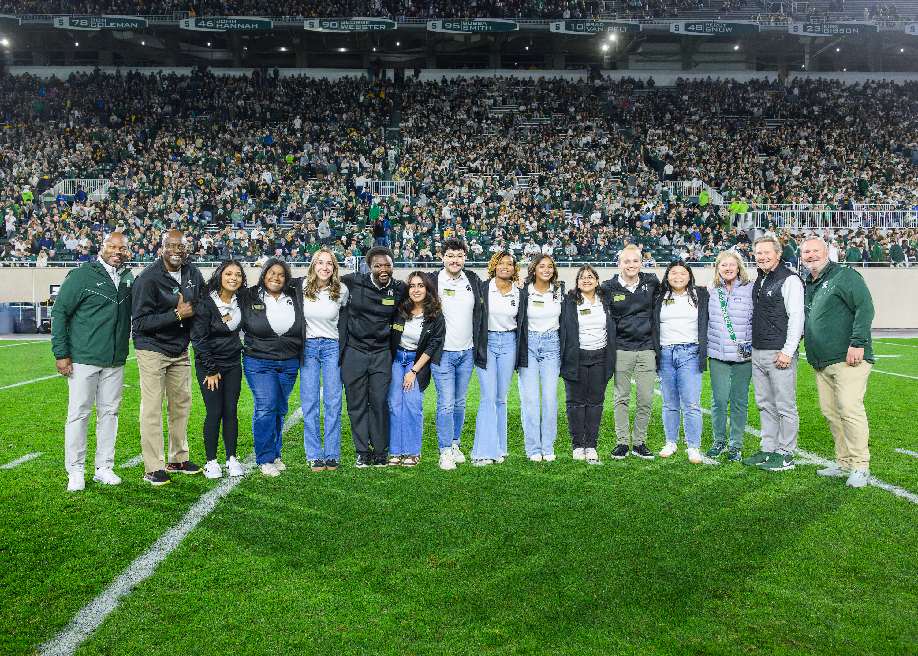 Homecoming court members at halftime with Kevin Guskiewicz, Allan Haller and Sam Vincent.