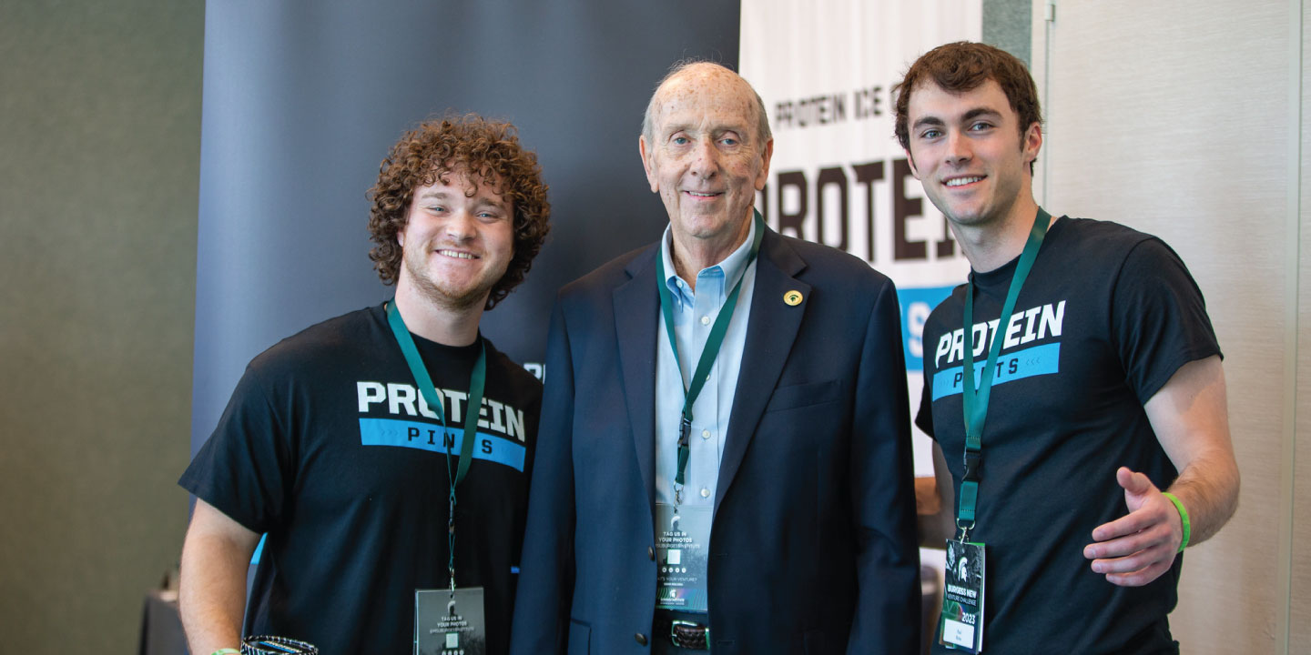 Three men pose for a photo