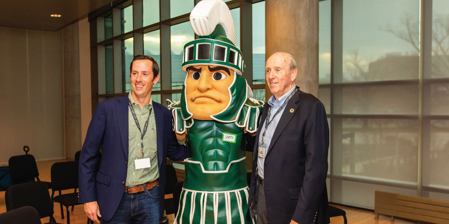 Two men pose with Sparty