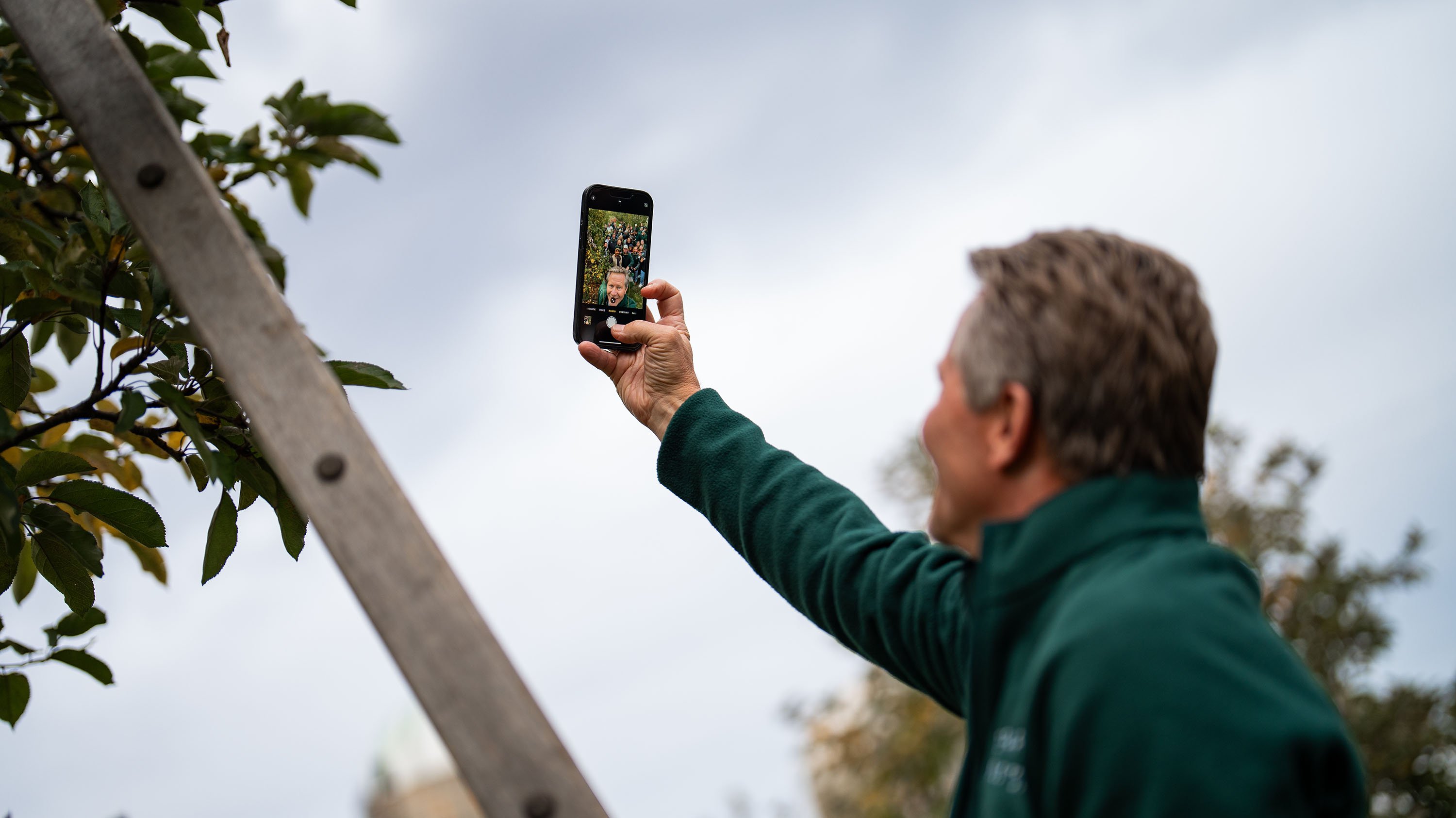 A man taking a selfie on his phone.