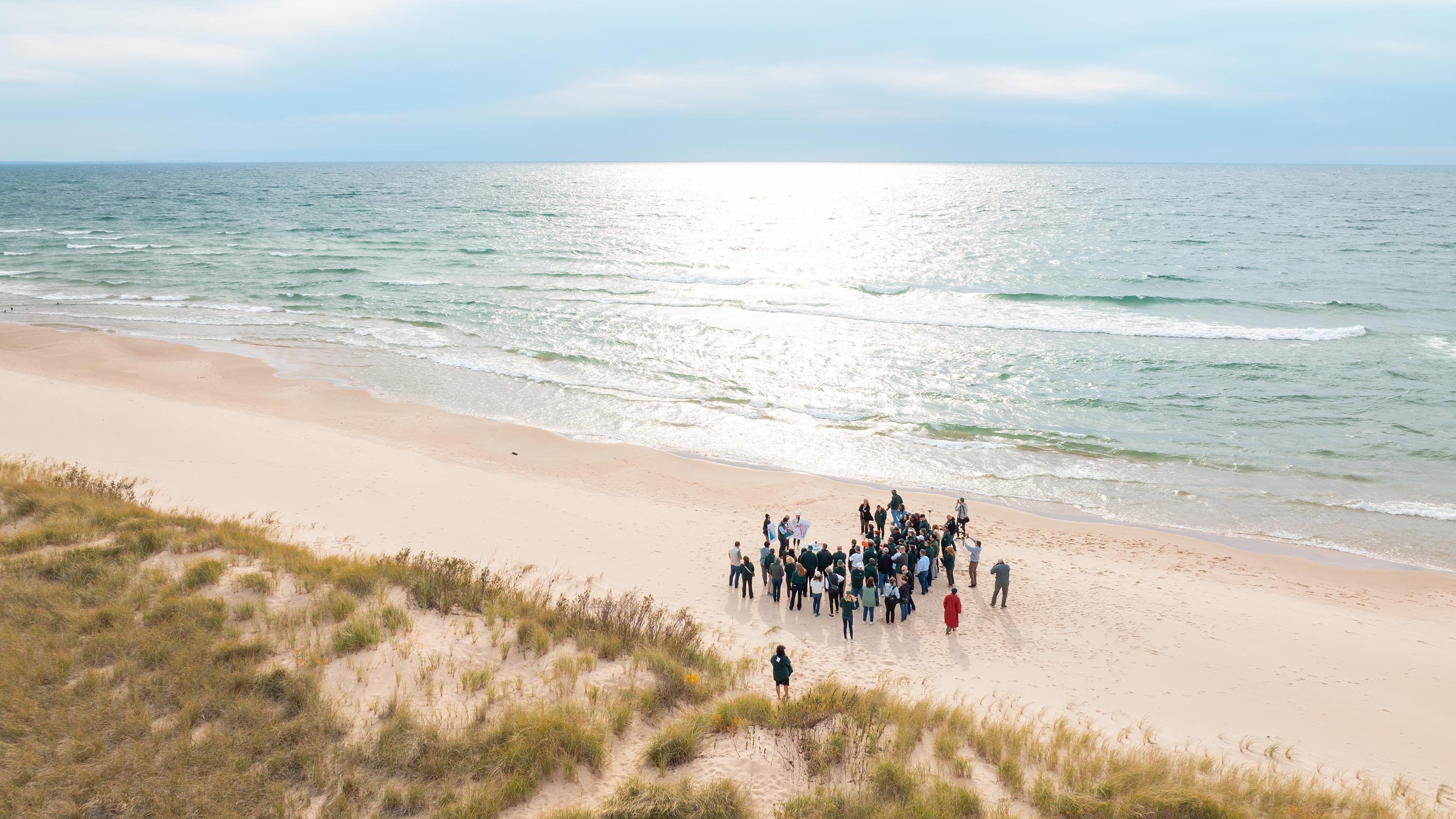 An aerial photograph of a group of people on a beach.