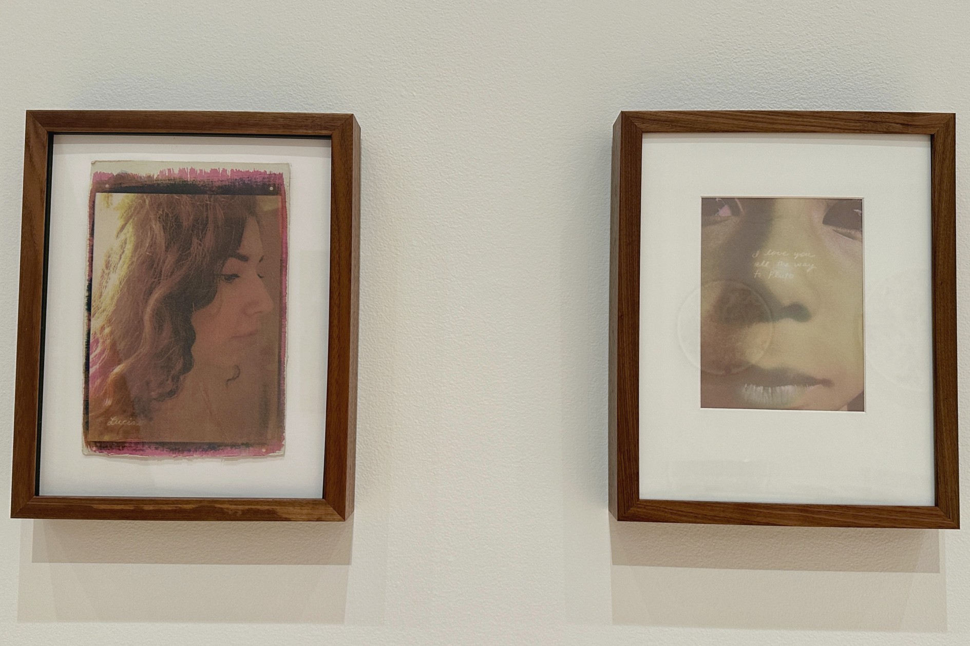Two framed portraits hang side-by-side on a wall.