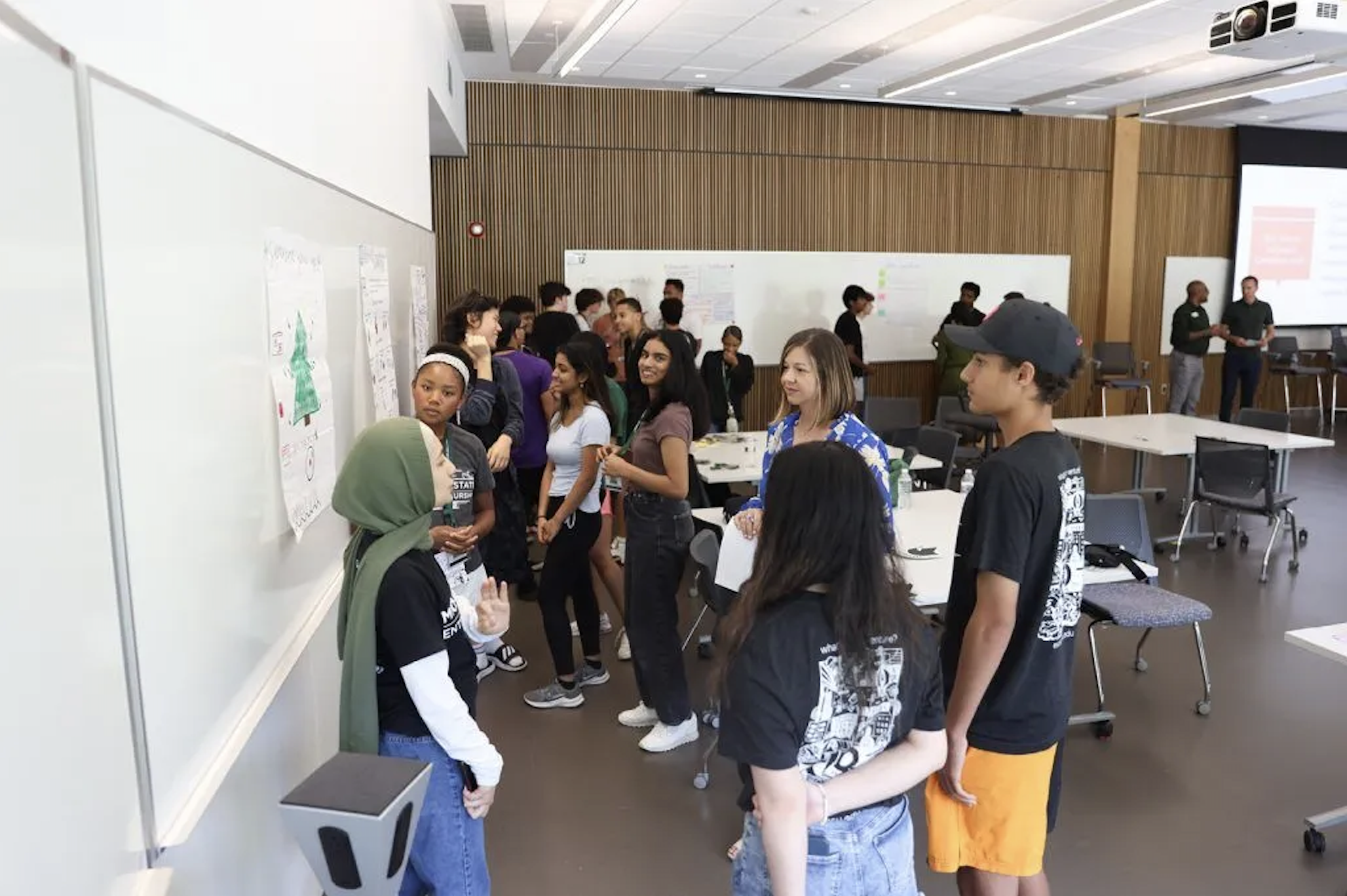 People talking in a classroom.