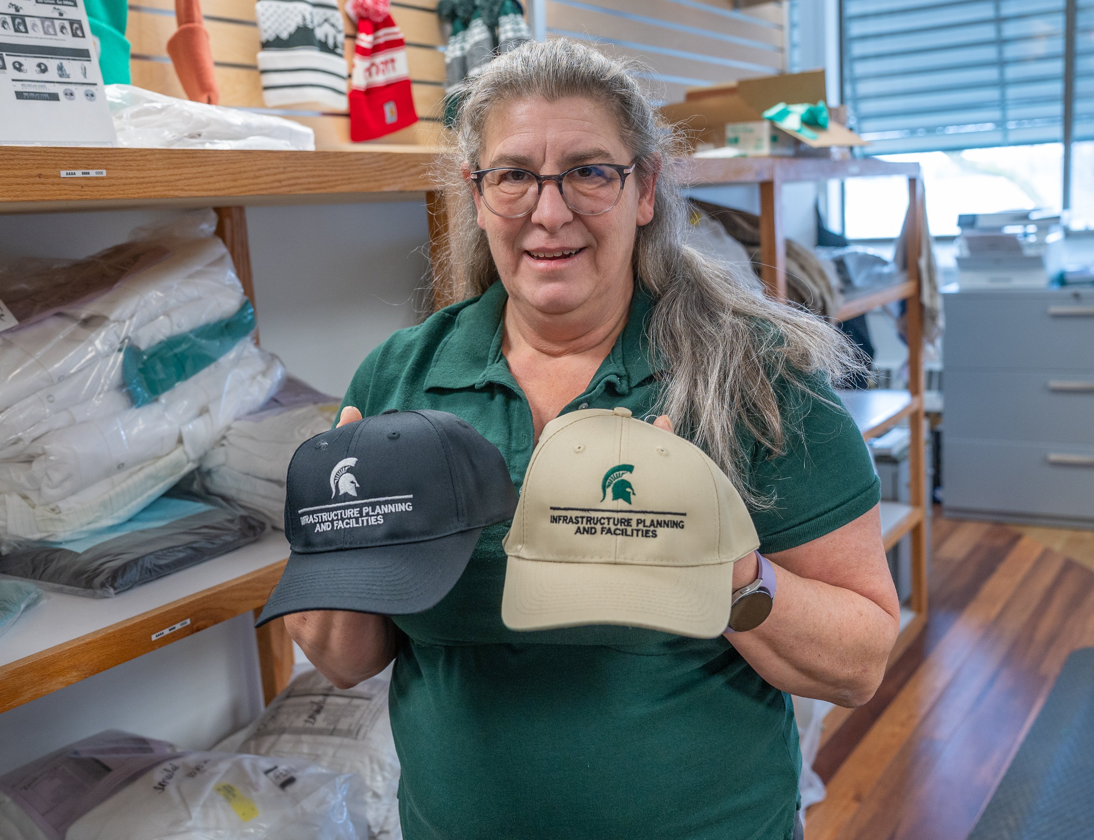Billie Jo Wilburn holds two of the millions of pieces she has branded MSU.