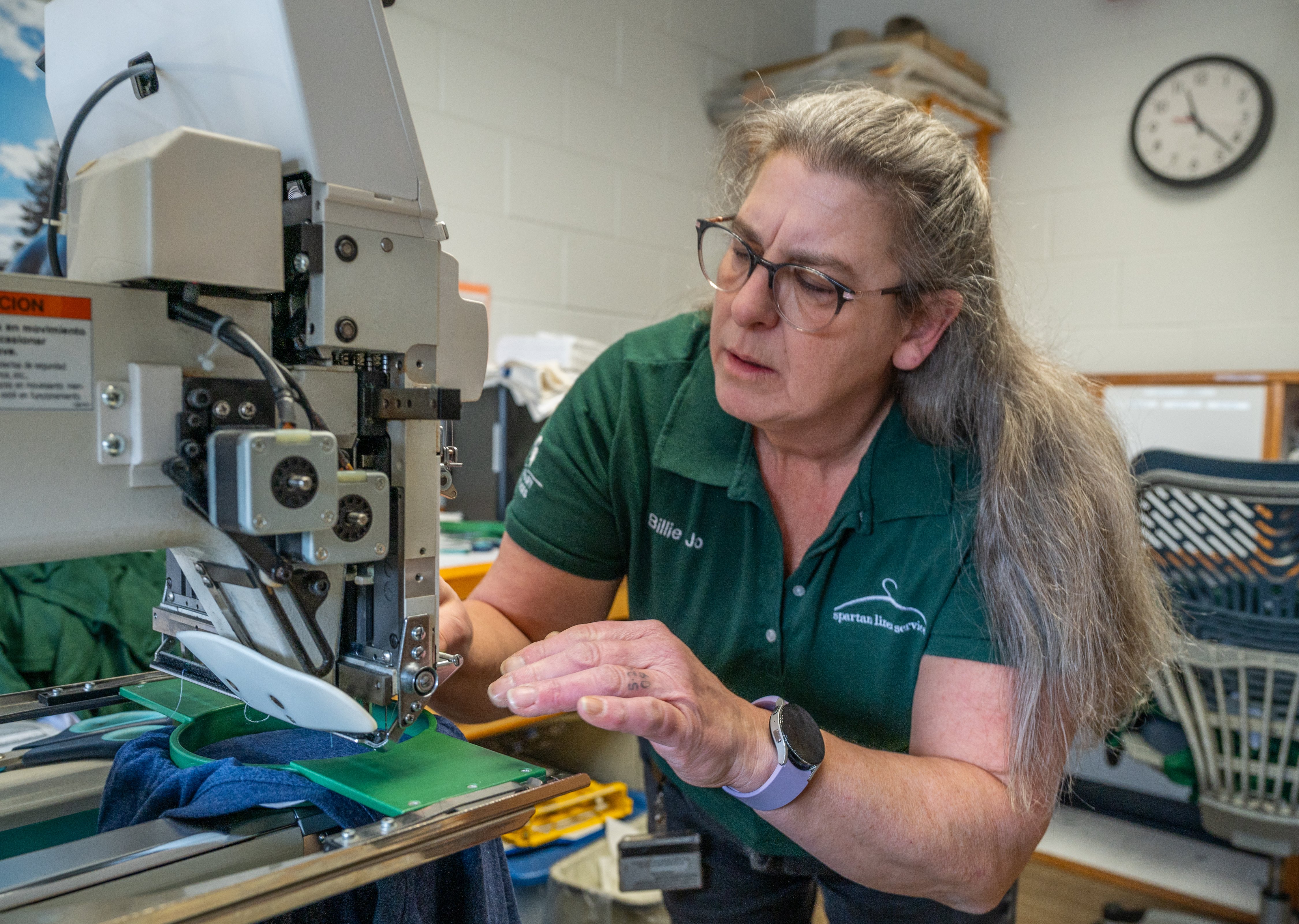 Billie Jo Wilburn checks the alignment on the shirt to make sure it?s straight.