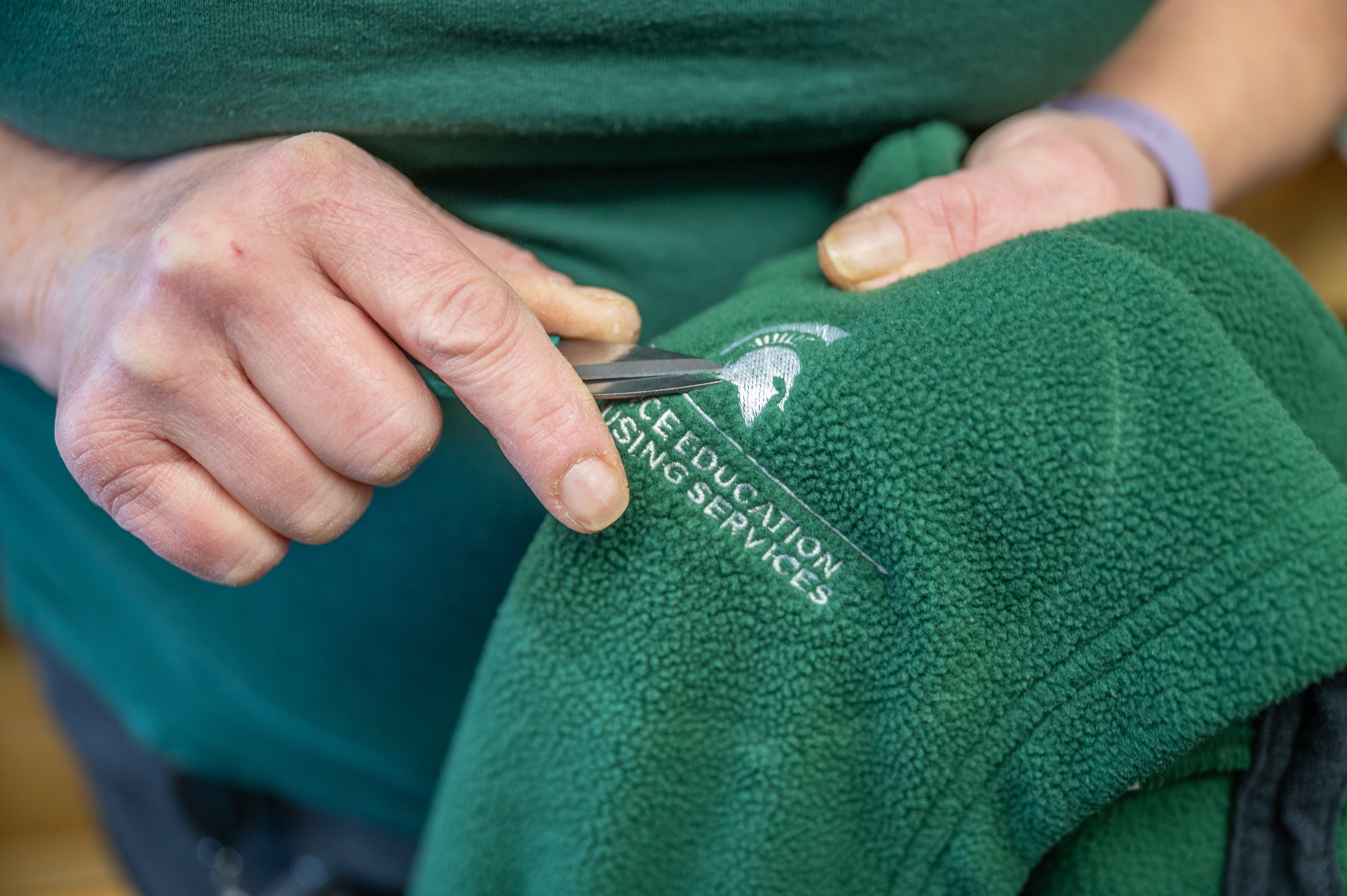 Closeup view of how clothing become the MSU brand.