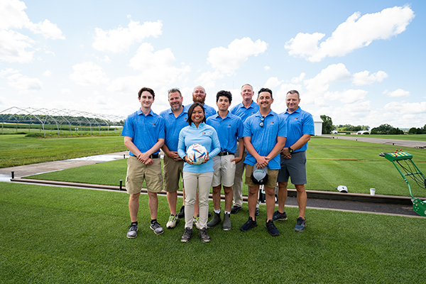 MSU turfgrass research team standing with turfgrass plots from left to right: Elijah Delaney, Ryan Bearss, Evan Rogers, Zach Flink, Trey Rogers, Jake Kilby, Jesse Sholl with Jackie Guevara in front (center)