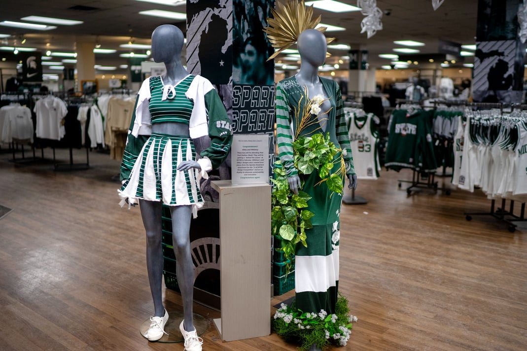 The winning designs created by Abigail Jones (left) and Whitney Howard (right) on display through Feb. 9 at the Spartan Bookstore located in MSU’s International Center.