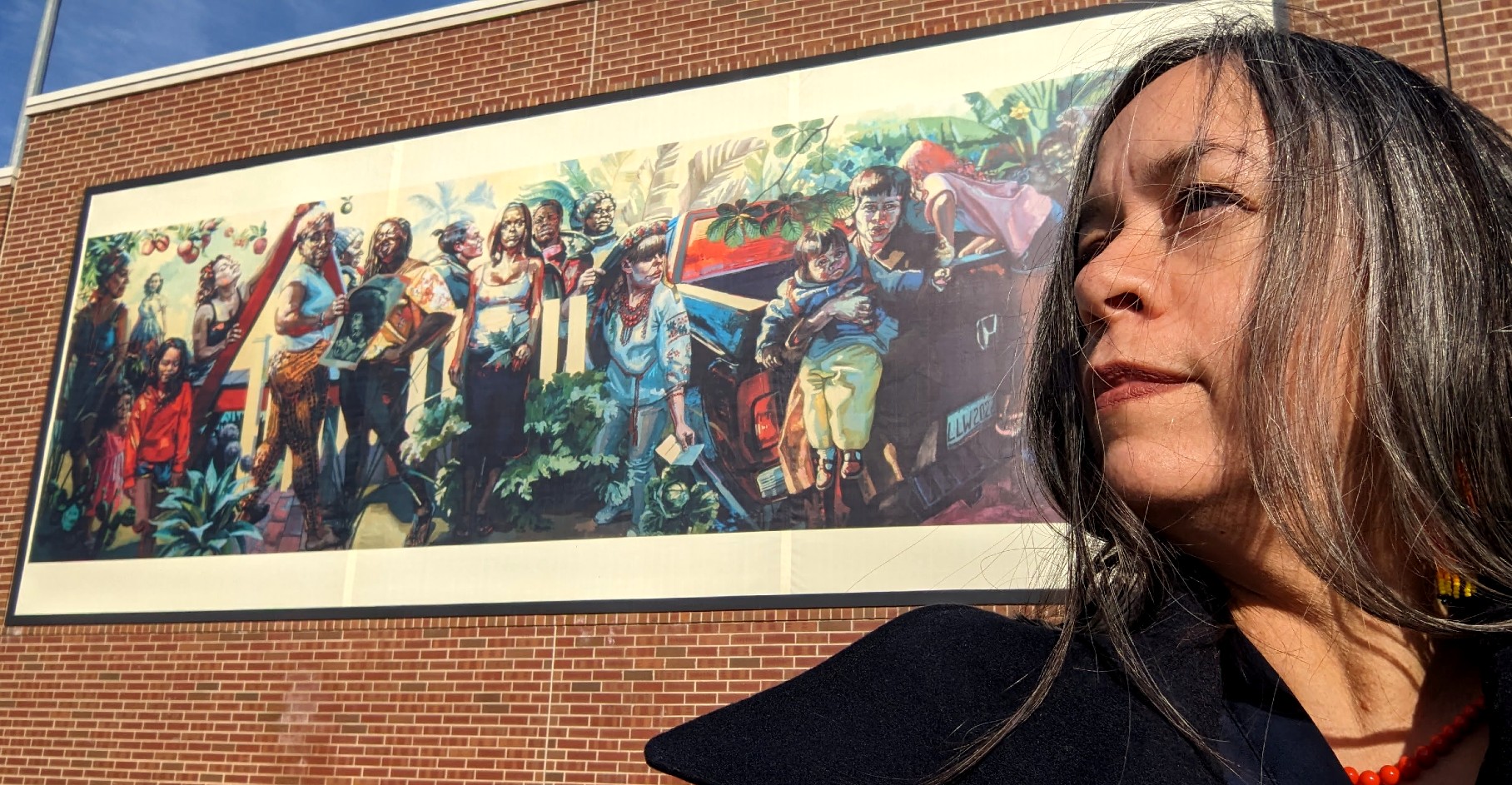Professor Teresa Dunn with the billboard-sized reproduction of her A Long Line of Women