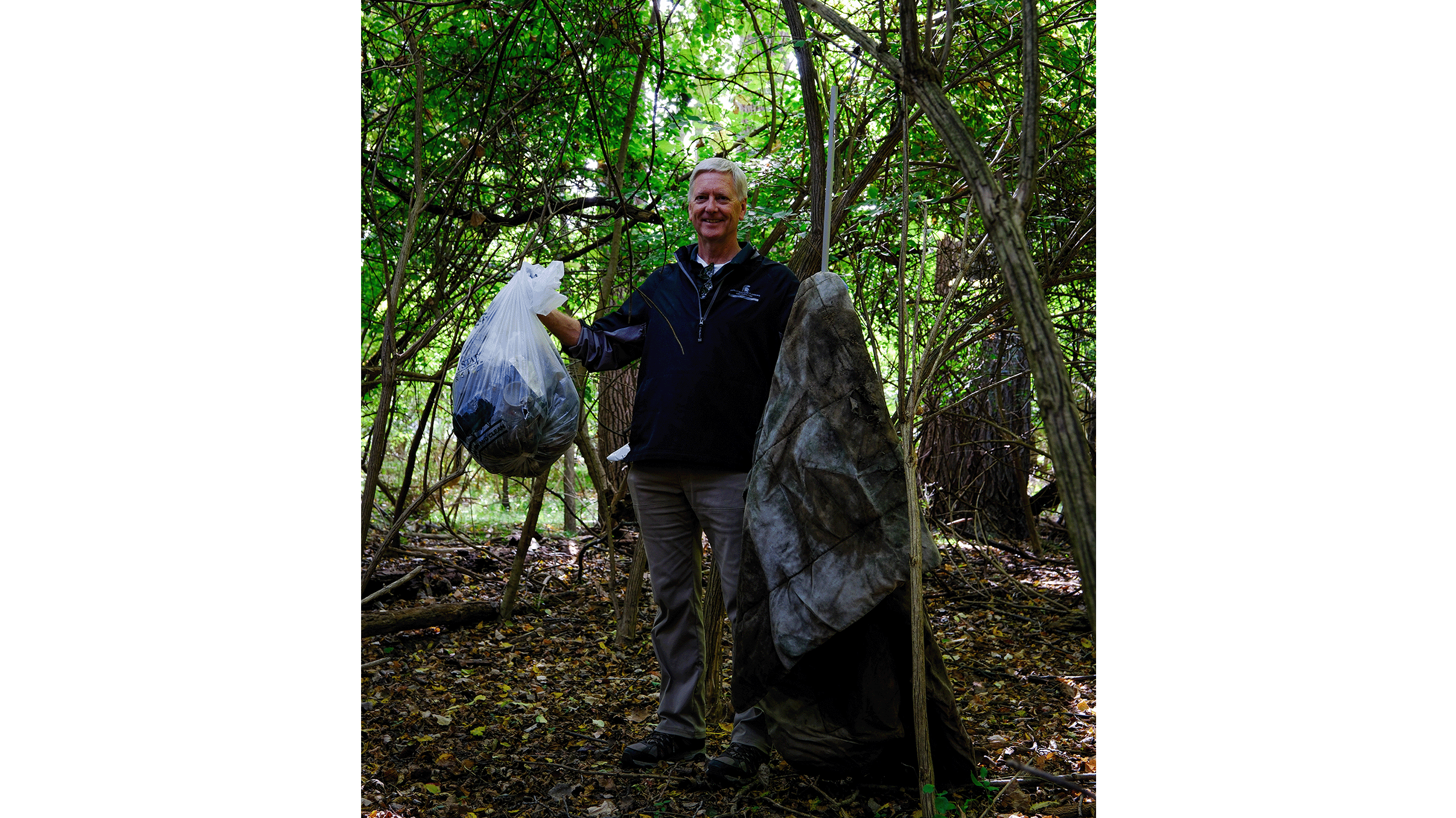 Person holding bags of trash