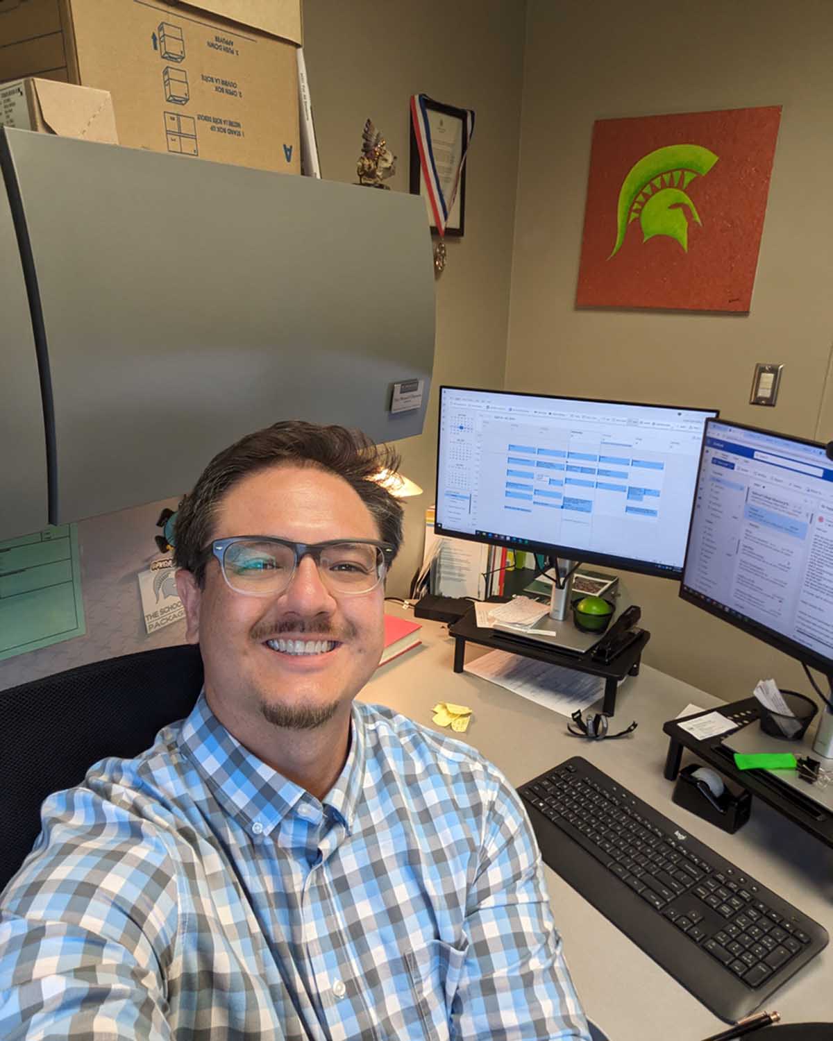 Troy Villanueva in office with Spartan decor