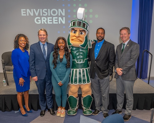 Members of Lansing Community College and MSU leadership, alongside an LCC student who won a $1,000 scholarship to LCC at the Envision Green event.