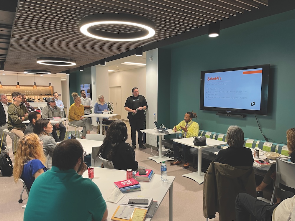 Participants in the Conquer Accelerator program listen to a presenter