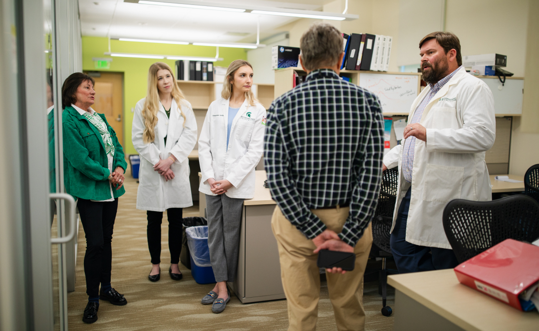 Ward and Mari Margaret Walstrom engage with MSU faculty and students, illustrating their commitment to advancing women's health research through their generous donation.