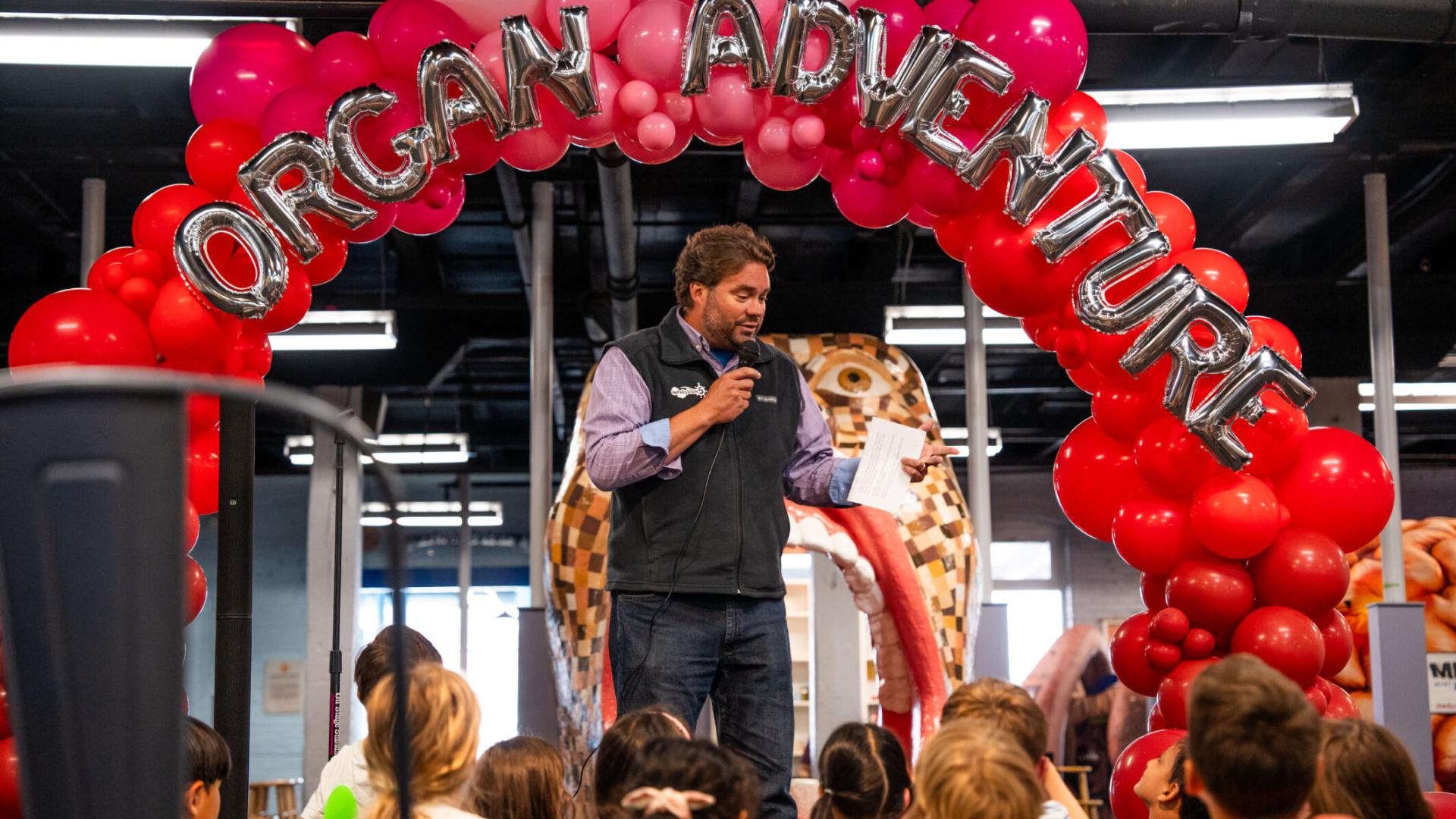  Erik Larson, executive director of Impression 5 Science Center, speaks to eager guests about the new Organ Adventure exhibit sponsored by MSU Health Care, open June 15. Photo by Nick Schrader, Michigan State University.