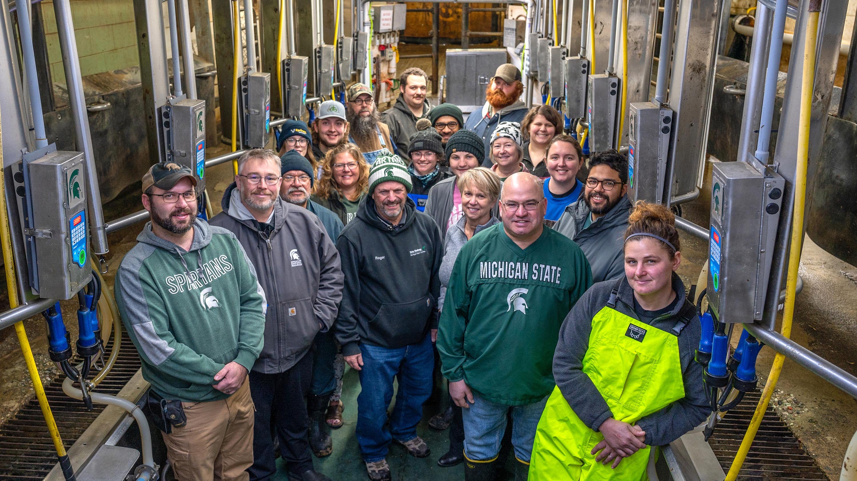 MSU Dairy Farm staff and leadership posing for a photo in the milking parlor