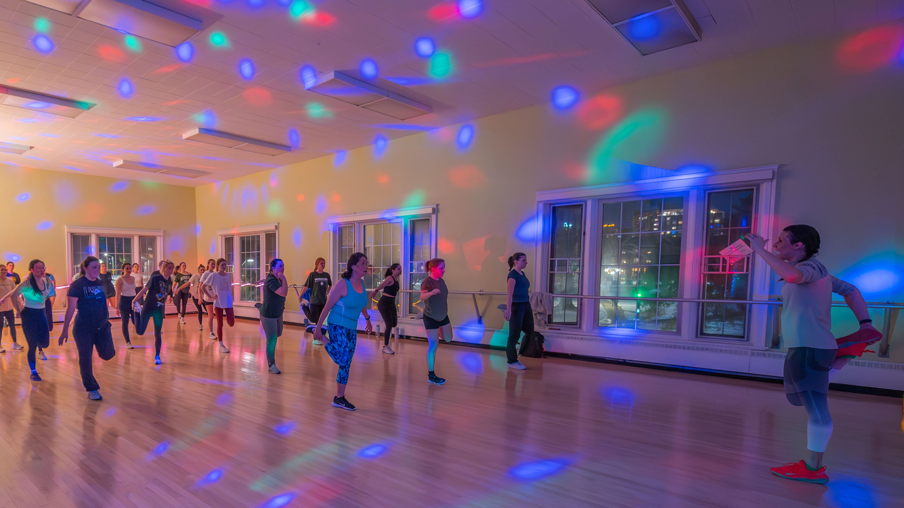 Fitness class in IM circle with colorful disco lighting