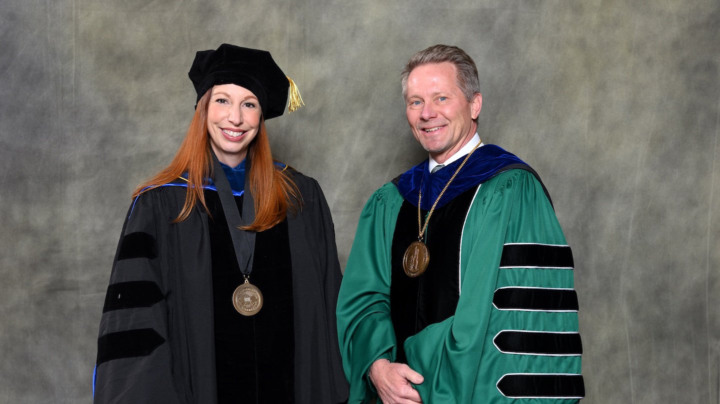 Endowed faculty member Gina Leinninger with MSU President Kevin Guskiewicz.