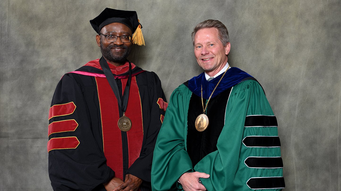 Endowed faculty member Titus Awokuse with MSU President Kevin Guskiewicz.